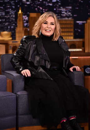 Roseanne Barr sitting on a leather surface