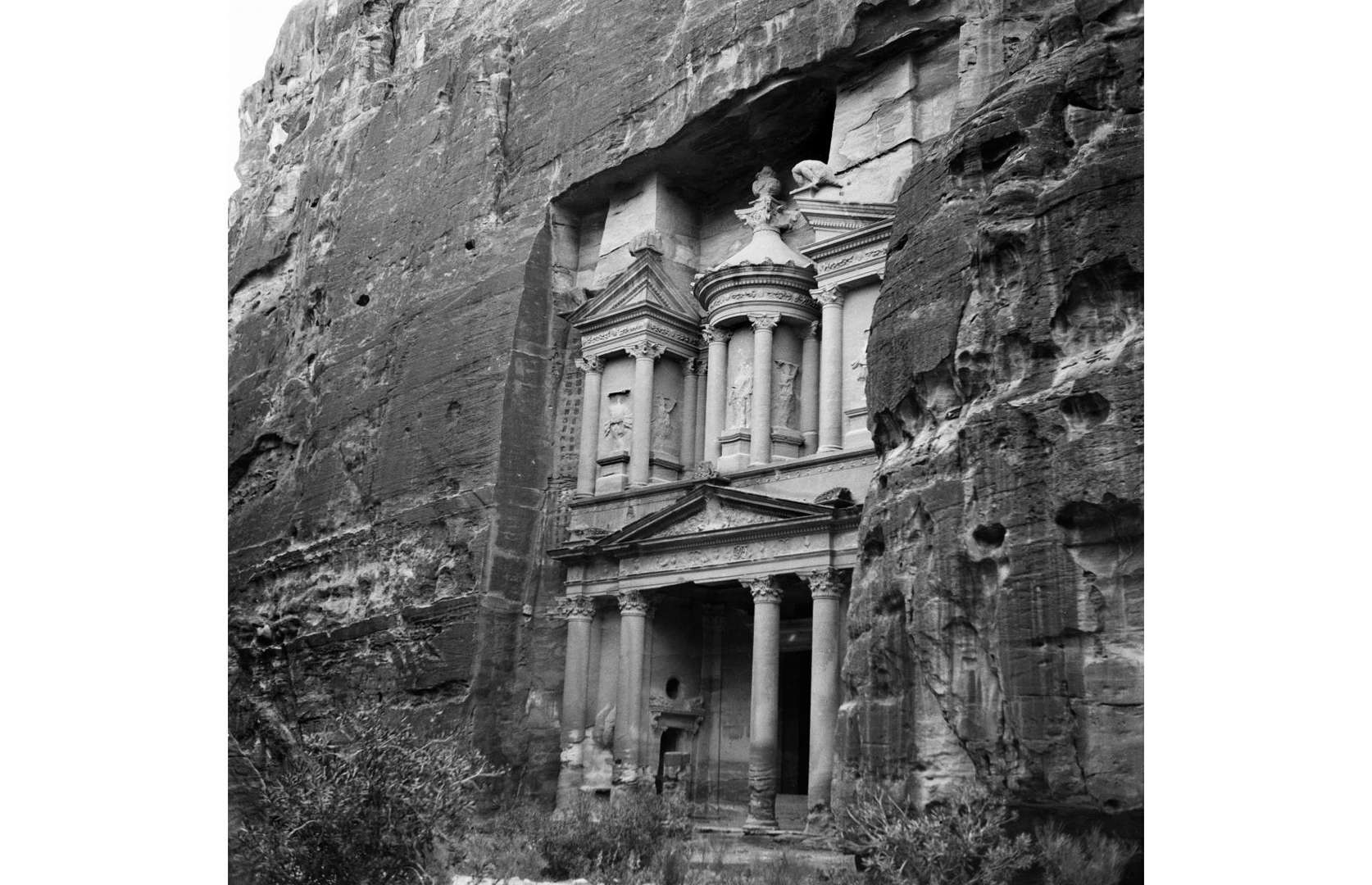 Slide 8 of 41: Hewn from mighty bluffs of red sandstone, the Treasury (or Al-Khazneh) is the greatest wonder left behind in the ancient city of Petra. The city is thought to have thrived from around 400 BC and experts believe that the elaborate Treasury served as a royal mausoleum. Europeans tracked down the incredible ruins in the early 1800s and the site gradually established itself as a tourist destination. This close-up shot taken circa 1900 shows off the Treasury's stunning columns and carvings.