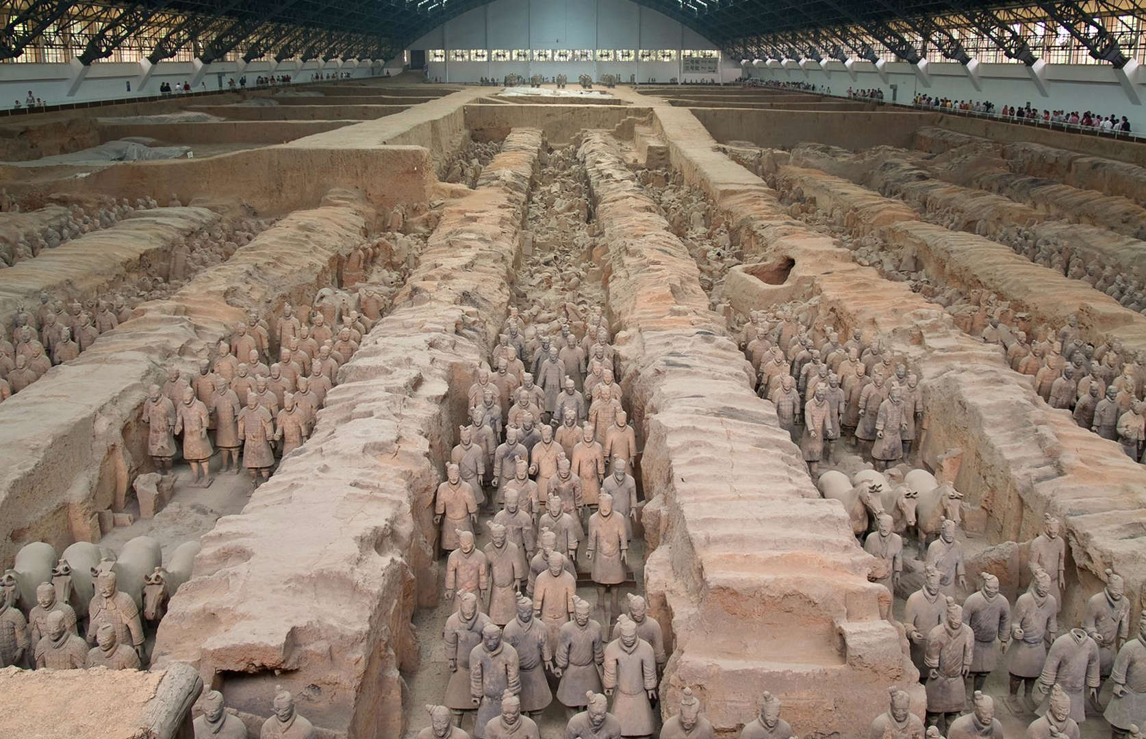 Slide 29 of 41: The figures, buried close to the mausoleum of Qin Shi Huang (founder of the Qin dynasty), are thought to date to the 3rd century BC and were likely created to protect the late emperor in the afterlife. This current-day photograph shows the site after further excavations, which revealed even more terracotta effigies. Work at the site is ongoing with archaeologists suspecting that yet more soldier-filled pits will be uncovered.
