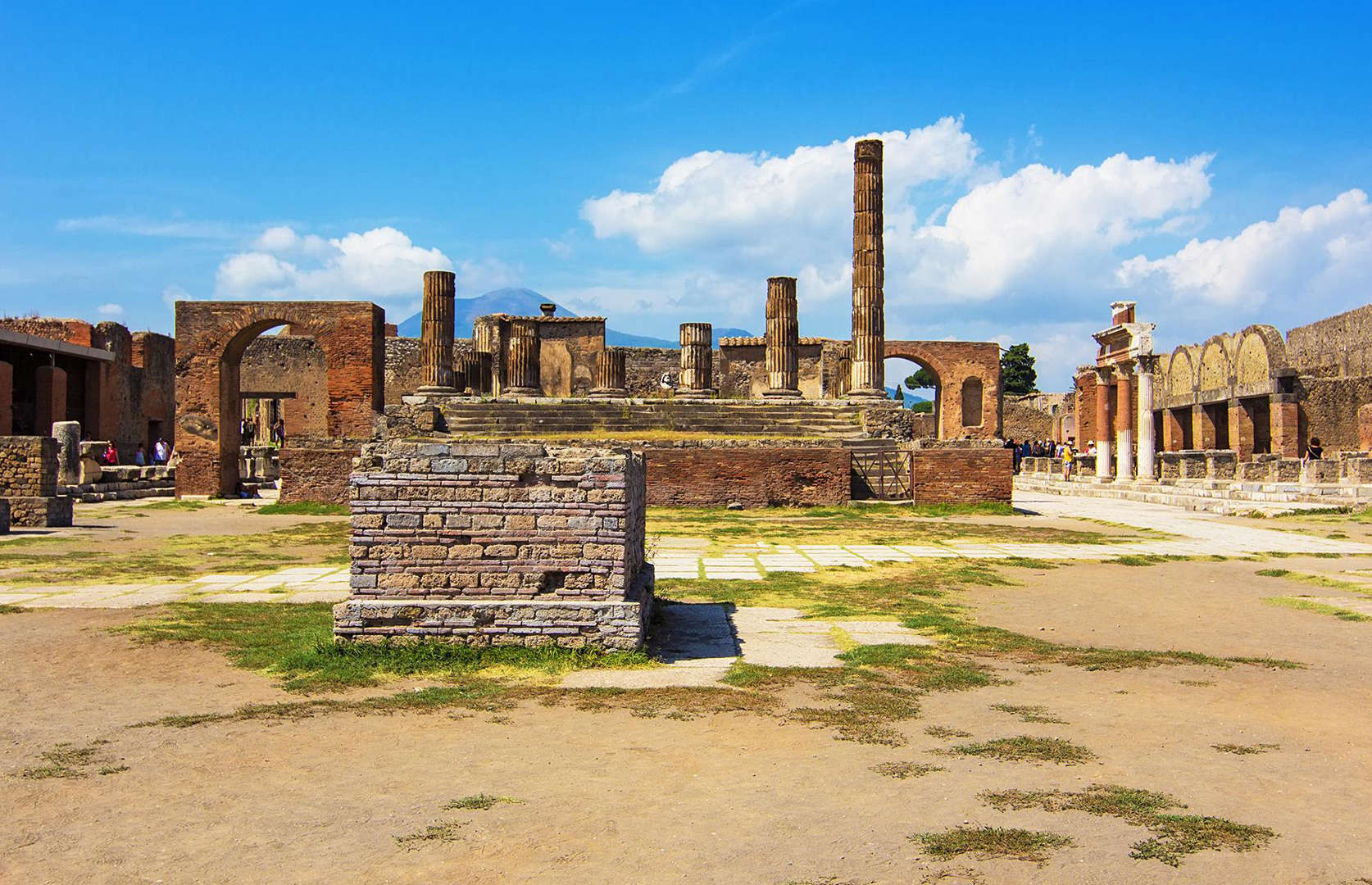 Slide 33 of 41: A similar view of Pompeii's Forum is captured here in the present day. Still the ruins are painstakingly preserved and you can spot tourists milling about the ancient remnants. Archaeological work continues to uncover more about Pompeii's residents too. From ongoing excavations, experts have been able to reveal everything from their political ideals to their lunch choices... Take a look at more amazing lost cities rediscovered