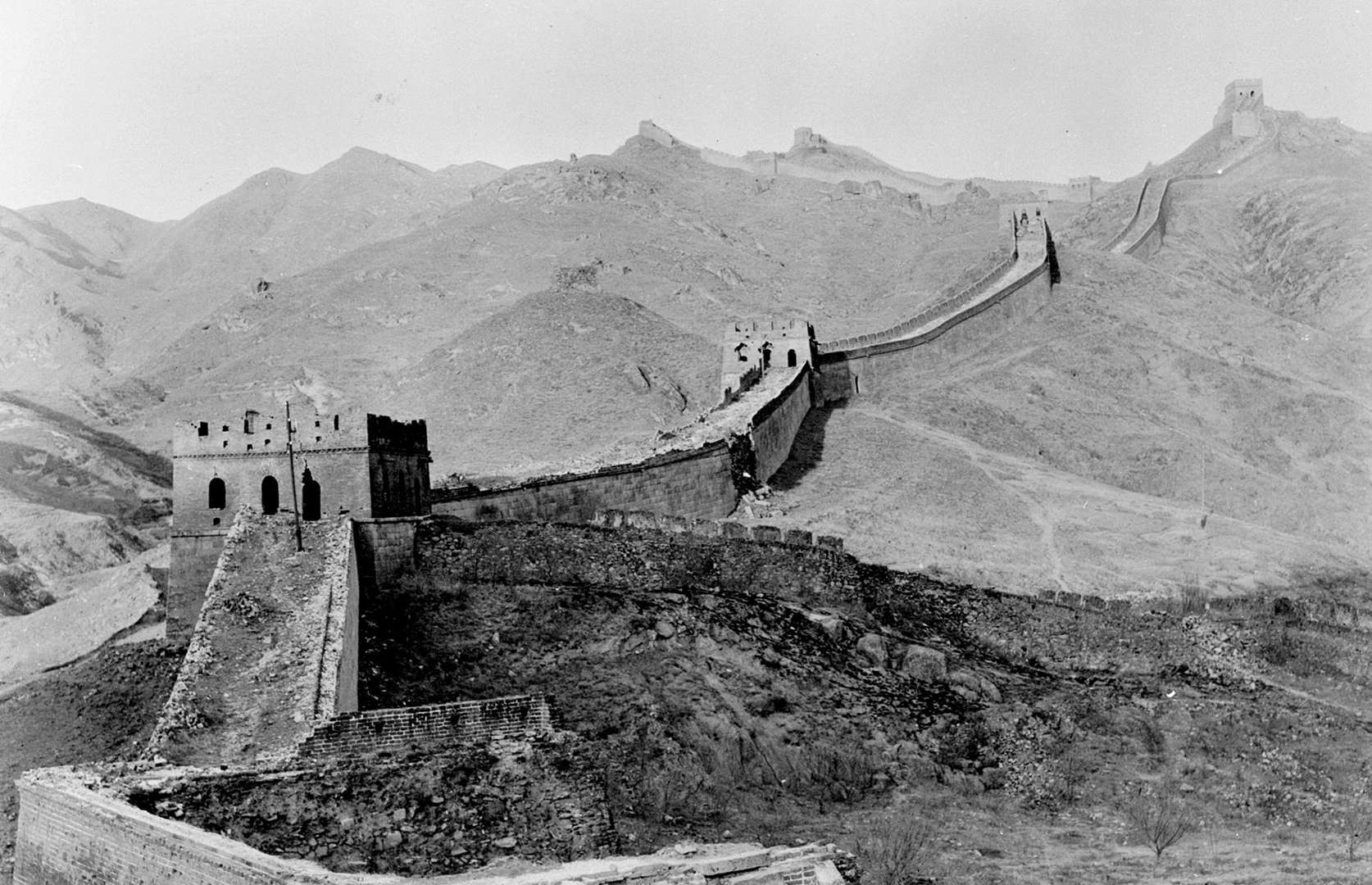 Slide 40 of 41: The scale of China's Great Wall is immense: it wriggles out for around 13,171 miles (21,197km) according to the most recent estimates and is punctured by hulking watch towers. While the wall's roots go as far back as the 7th century BC, the best-preserved sections (one of which is pictured here) date to the Ming Dynasty (from the 14th to the 17th centuries). The most touristed segment, at Badaling, was also restored in the 1950s, the same decade that this photo was captured.