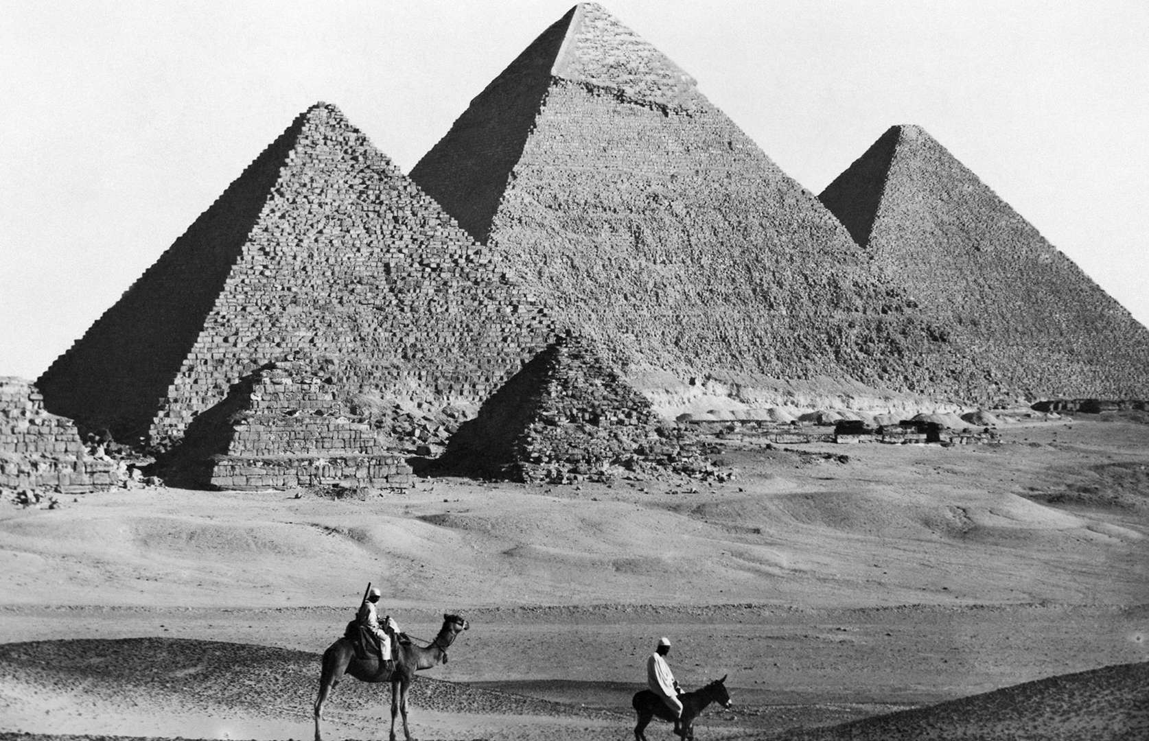 Slide 4 of 41: If this photo wasn't black and white, you'd probably think it was a modern-day shot. That's because the colossal Pyramids of Giza – built around 4,500 years ago – have changed little over the past centuries. They didn't always look like this, though. According to Smithsonian, the limestone was originally worked and smoothed with a sandstone brick, leaving a polished white finish that glinted in the sun. This picture captures the much more familiar, weather-beaten structures sometime in the late 1800s or early 1900s.