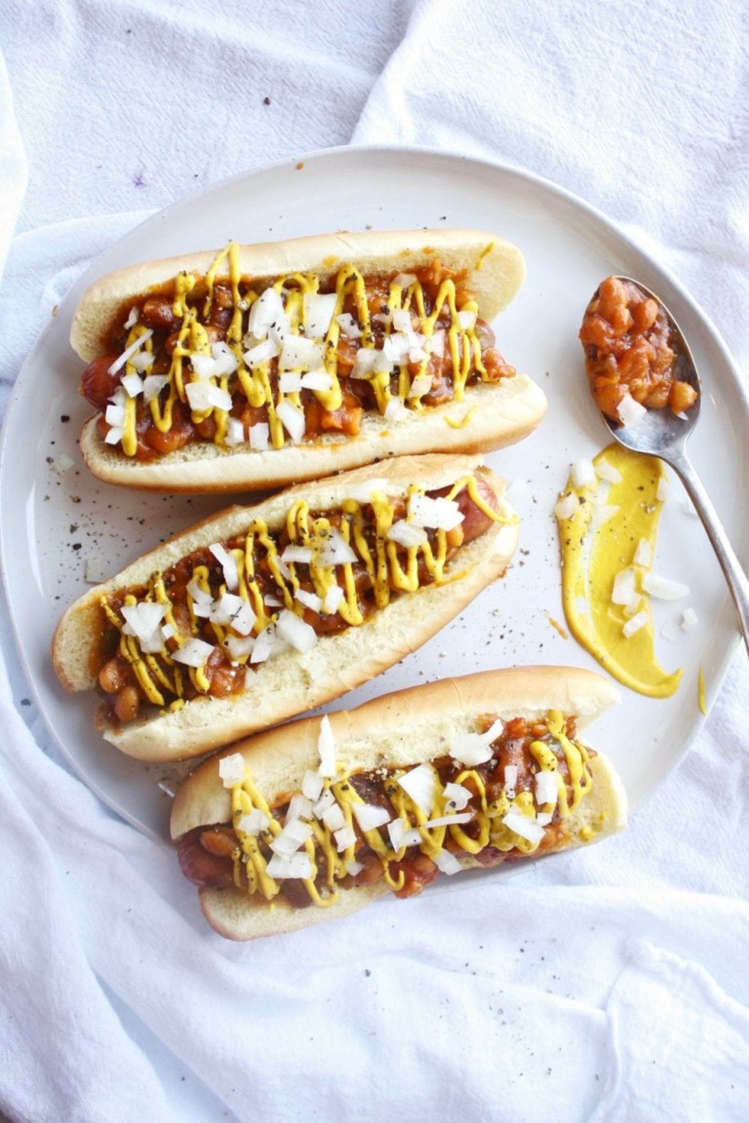 <p>Savory baked beans make for an absolutely delicious hot dog topping, paired with a simple combo of diced onion and mustard. Whether you make the beans from scratch or prefer the canned variety, it's the kind of meal you need in your weeknight dinner rotation. <a href="https://www.thegarlicdiaries.com/baked-bean-and-onion-dogs/" rel="nofollow noopener">Get the recipe here.</a></p>