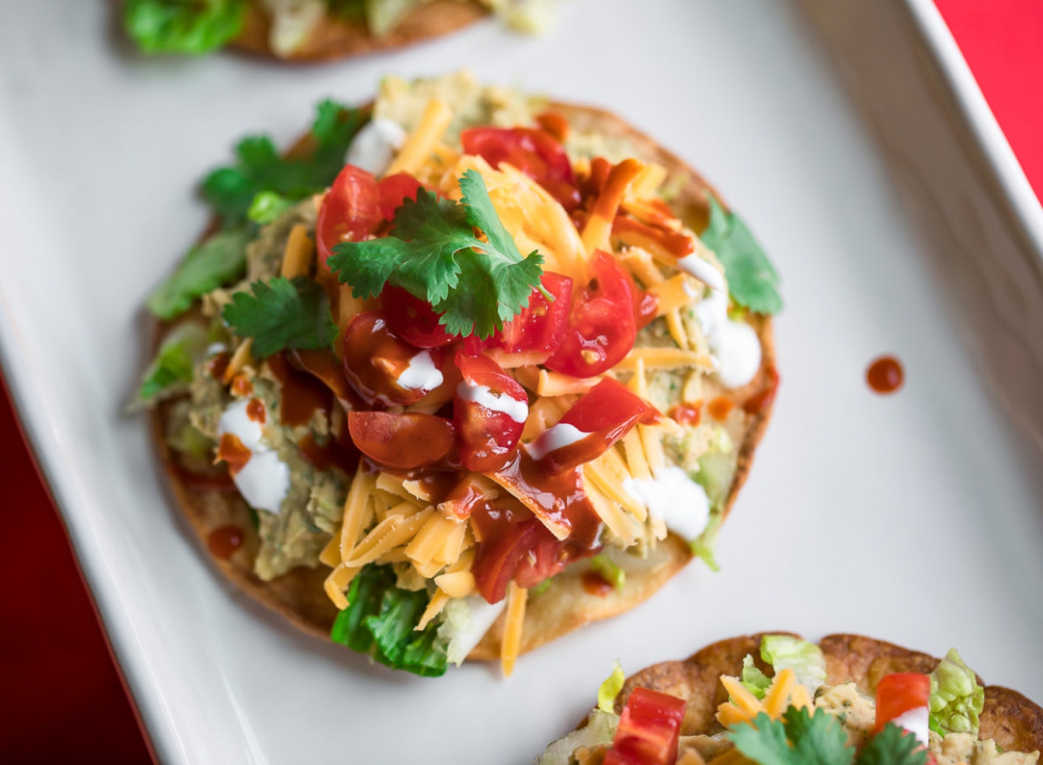 <p>Made with a budget-friendly can of white beans, these loaded tostadas would make for an excellent meat-free lunch or dinner the whole family will enjoy. Topped with all the goodness of cheese, fresh veggies, cilantro and creamy condiments, they are bursting with flavor in every bite. <a href="https://peasandcrayons.com/2020/03/white-bean-tostadas.html" rel="noopener">Get the recipe here.</a></p>