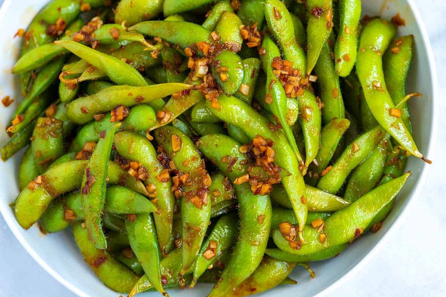 <p>Turn plain ol' edamame beans into a delightful snack with spicy sambal oelek and a handful of Asian cooking staples. You'll get all the flavor in the zingy sauce as you pop the beans out each time. <a href="https://www.inspiredtaste.net/45662/spicy-edamame/" rel="noopener">Get the recipe here.</a></p>