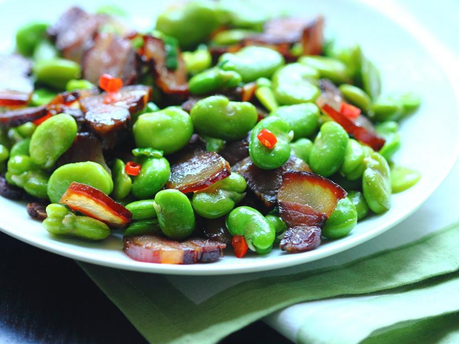 <p>Fava beans take on the most delish spicy, smoky flavors with this Chinese-style stir fry you'll want to make again and again. All you need are 6 ingredients, including Chinese bacon made from marinated, dried pork belly (cue drooling now). <a href="https://soyricefire.com/2013/05/19/stir-fried-fava-beans-with-chinese-bacon/" rel="noopener">Get the recipe here.</a></p>