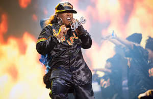 a person standing on a stage: After a decade out of the spotlight, few thought that Missy Elliott would ever return to the stage, let alone release her own music again.  In 2015, she surprised the world with a comeback performance at the Super Bowl XLIX halftime show with ‘Roar’ singer Katy Perry and performed a medley of some of her biggest hits, ‘Get Ur Freak On’, ‘Work It’, and ‘Lose Control’.  But it wasn’t a one-off for Elliott, as months later she released her first new music in 10 years, when she released her single ‘WTF (Where They From).’ In 2019, she then released an EP titled ‘Iconology’.