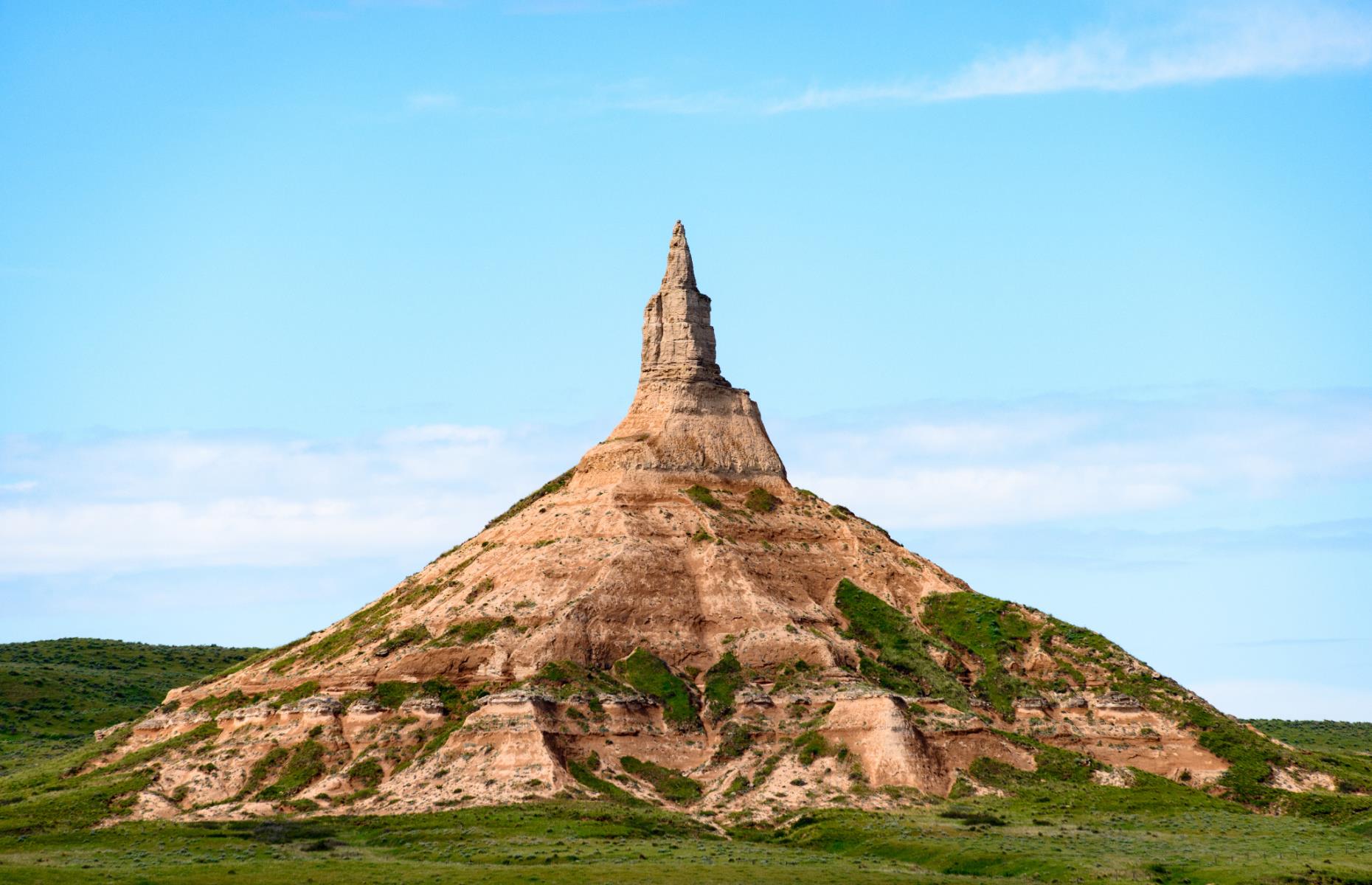 <p>Another natural landmark that helped point pioneer migrants in the right direction, <a href="https://www.nps.gov/nr/travel/scotts_bluff/chimney_rock.html">Chimney Rock</a> was a beacon for travelers on the Oregon, California and Mormon trails. In fact, it’s mentioned repeatedly in the diaries of pioneers headed westward. Today the rock remains as it always has – surrounded by plains without any modern developments in sight.</p>