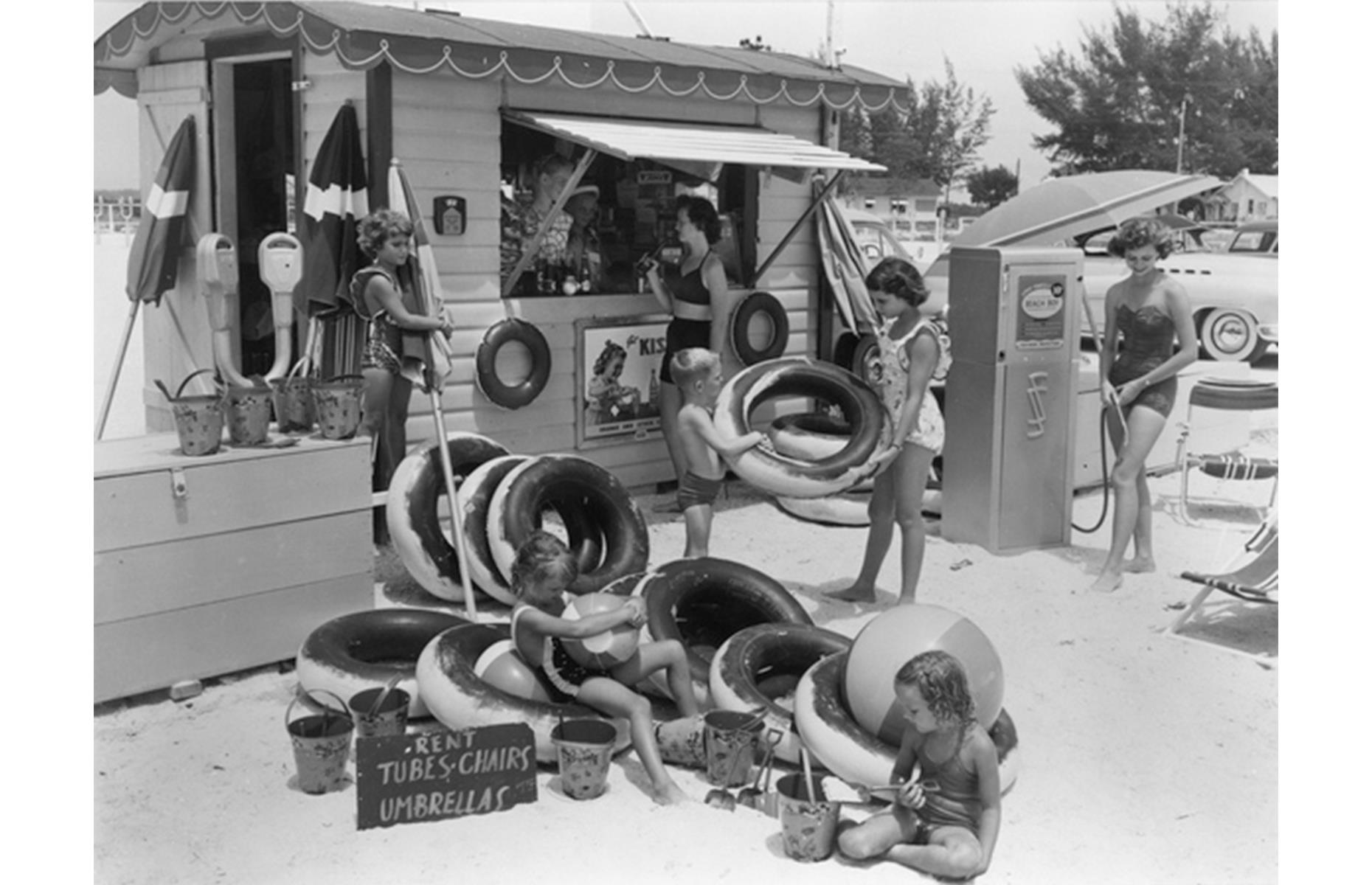 Close to St Pete, Treasure Island was another sun-drenched Florida city that pulled in the crowds over summer. This lovely 1951 shot shows a family hiring water donuts and umbrellas from a little wooden shack, readying themselves for Treasure Island's postcard-perfect beach.