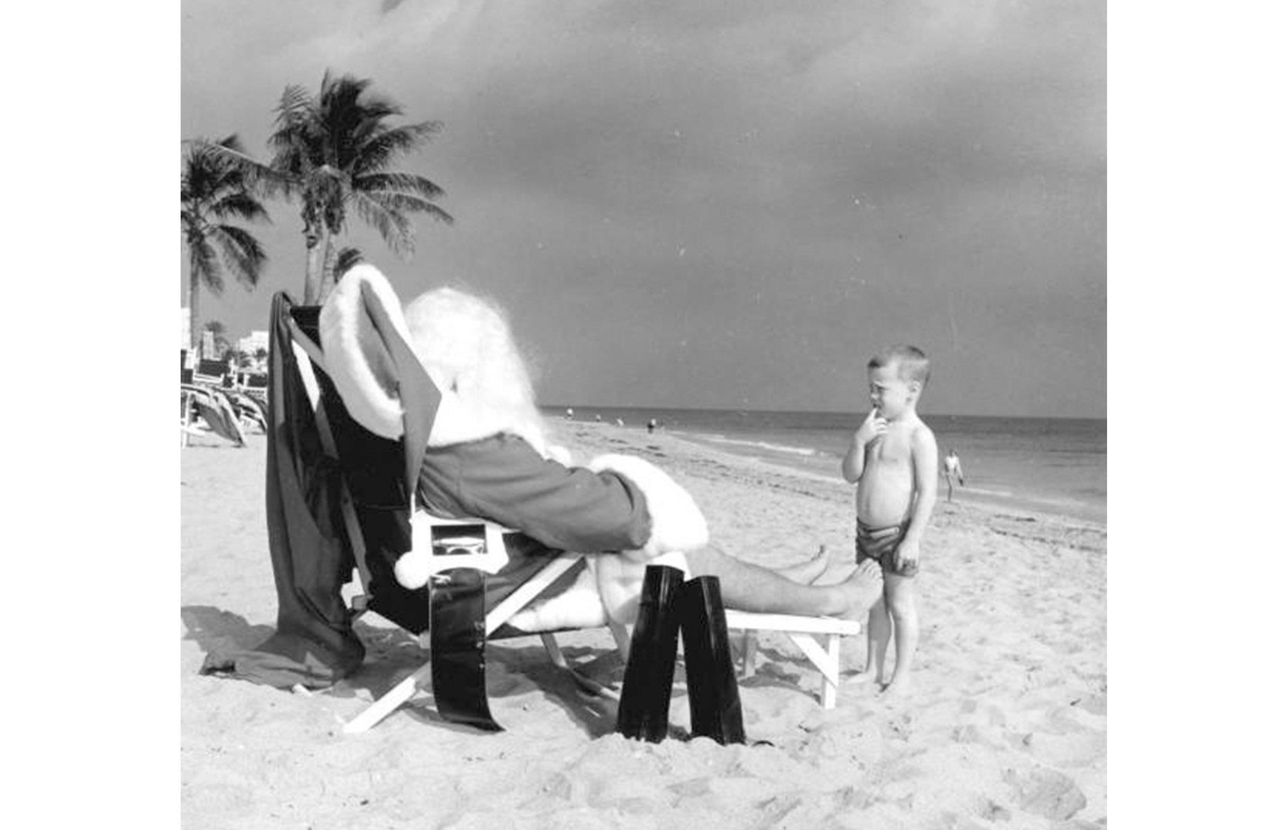Even Santa Claus couldn't resist the glorious white sands of the Sunshine State. In this 1964 snap, a curious child gazes up at Saint Nick as he dozes on a deck chair beneath the palms.