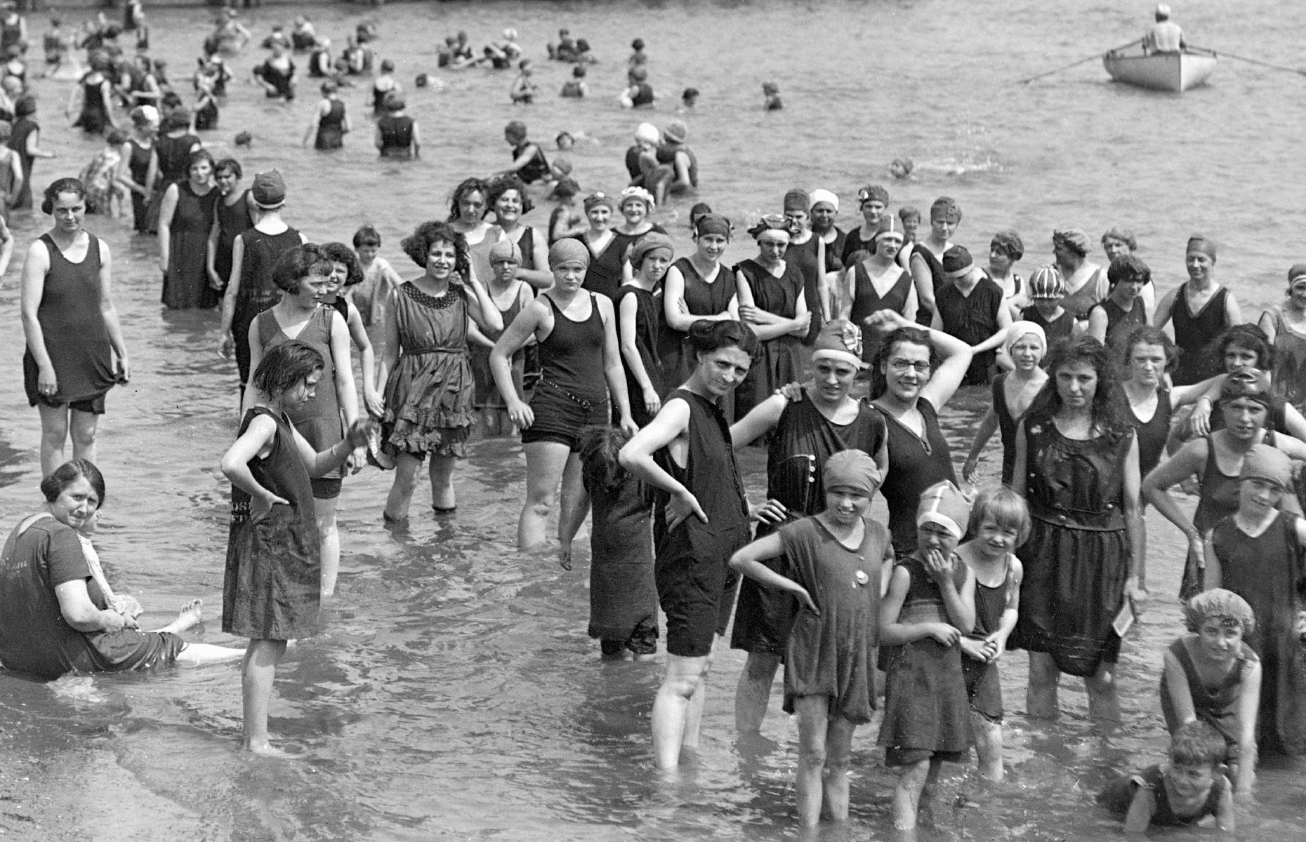 Less than two decades later and America's Atlantic shores look busier than ever. Snapped on a hot day circa 1919, this photo shows a large crowd of women and girls (in similar conservative dress) as they spill into the Atlantic Ocean off the coast of Massachusetts.