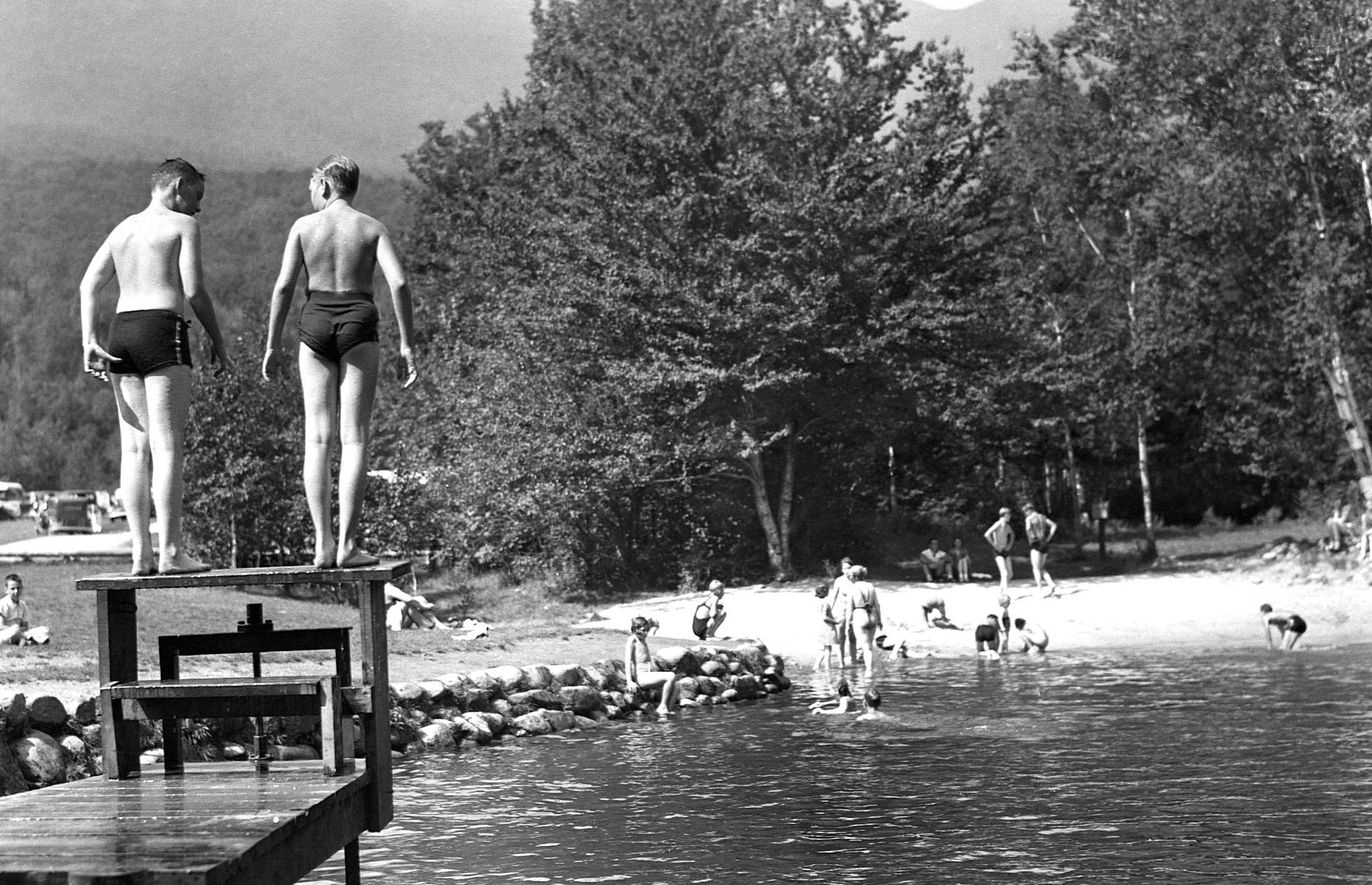 Some families eschewed the coast in favor of a woodland escape, opting for forested campsites or trailer parks like this one in New Hampshire. In this 1937 photograph, families enjoy the natural swimming pool at the Dolly Copp Forest Camp in the White Mountain National Forest. You can make out a huddle of motorhomes and trailers parked in background.