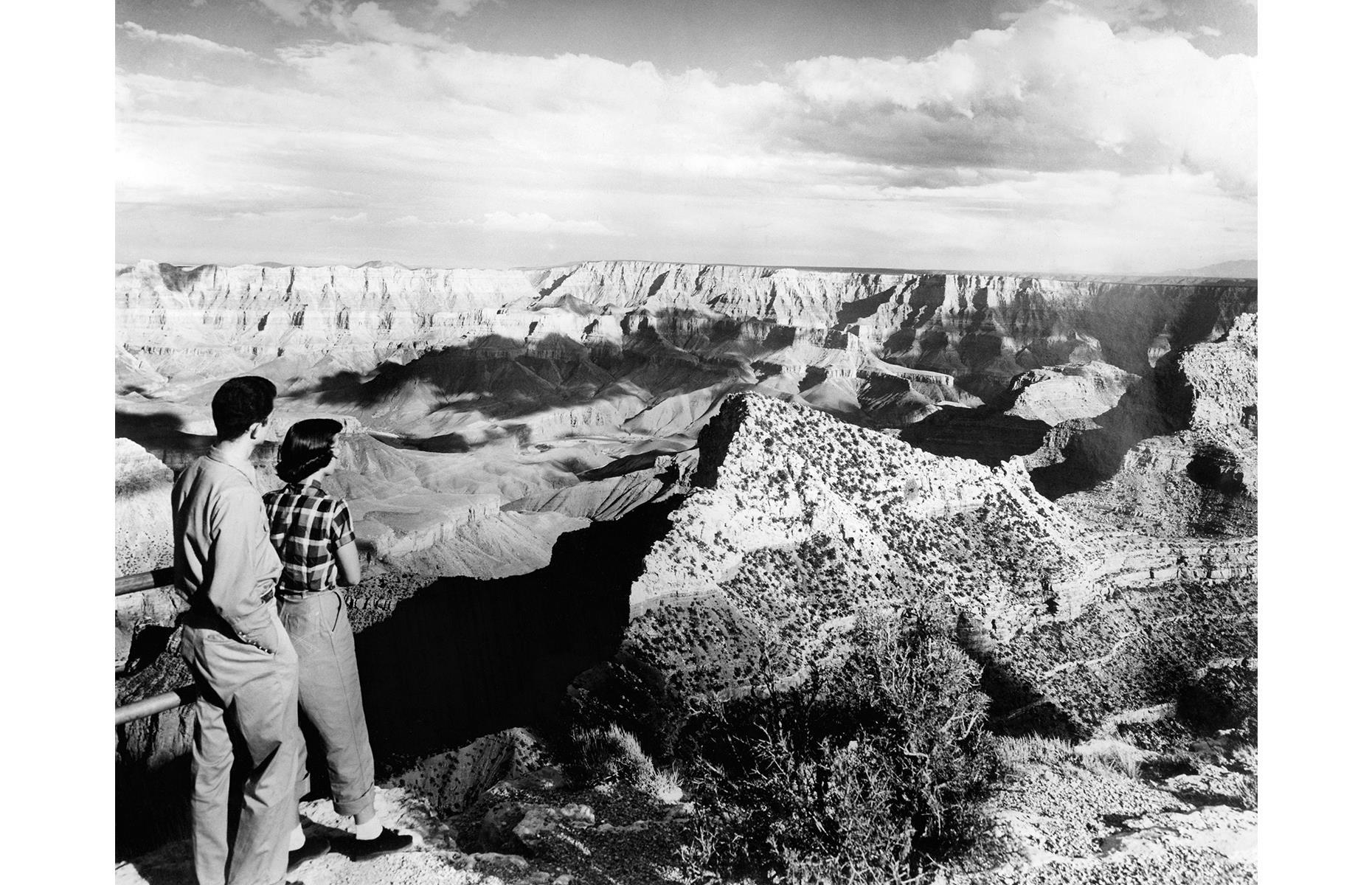Farther south, the Grand Canyon has been a top road-trip pitstop for decades, drawing vacationers in their droves come summer. This couple stand on a scenic overlook and gaze out in awe as the spectacular rocks roll out beneath them. The photo dates to the 1940s.