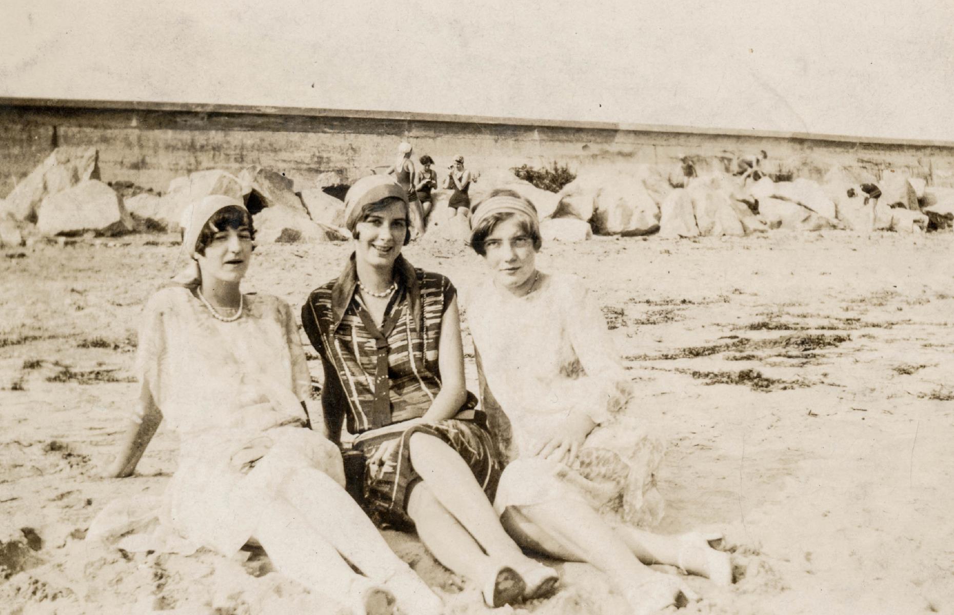 These finely dressed sunbathers are also basking on a Massachusetts strand. Set against a backdrop of rugged rocks and powder-fine sand, this trio of women sit on a beach near Marblehead in Essex County in the 1920s.