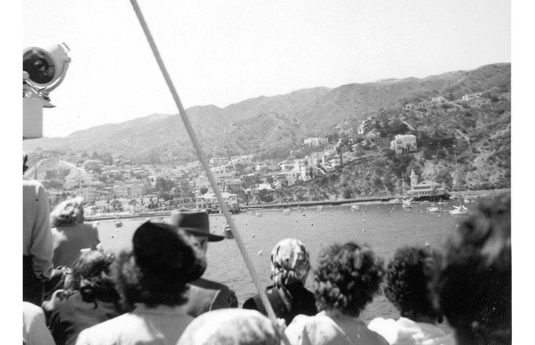 This photograph was taken some two decades later and shows the continued popularity of the Southern California isle. Here, in 1954, tourists clamor to see the view on a boat ride that skirts the island.