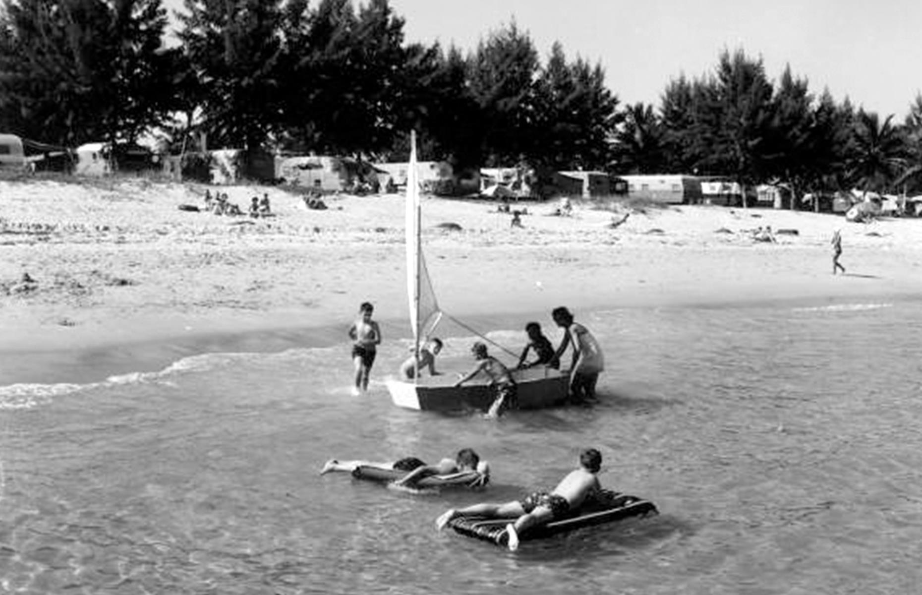 Plenty of Americans chose to pair a classic beach vacation with a trip in their trailer or motorhome. Photographed in 1953, a row of RVs line this beach in Hollywood, southeastern Florida, where families relax on the sand and kids float on inflatables in the Atlantic Ocean.