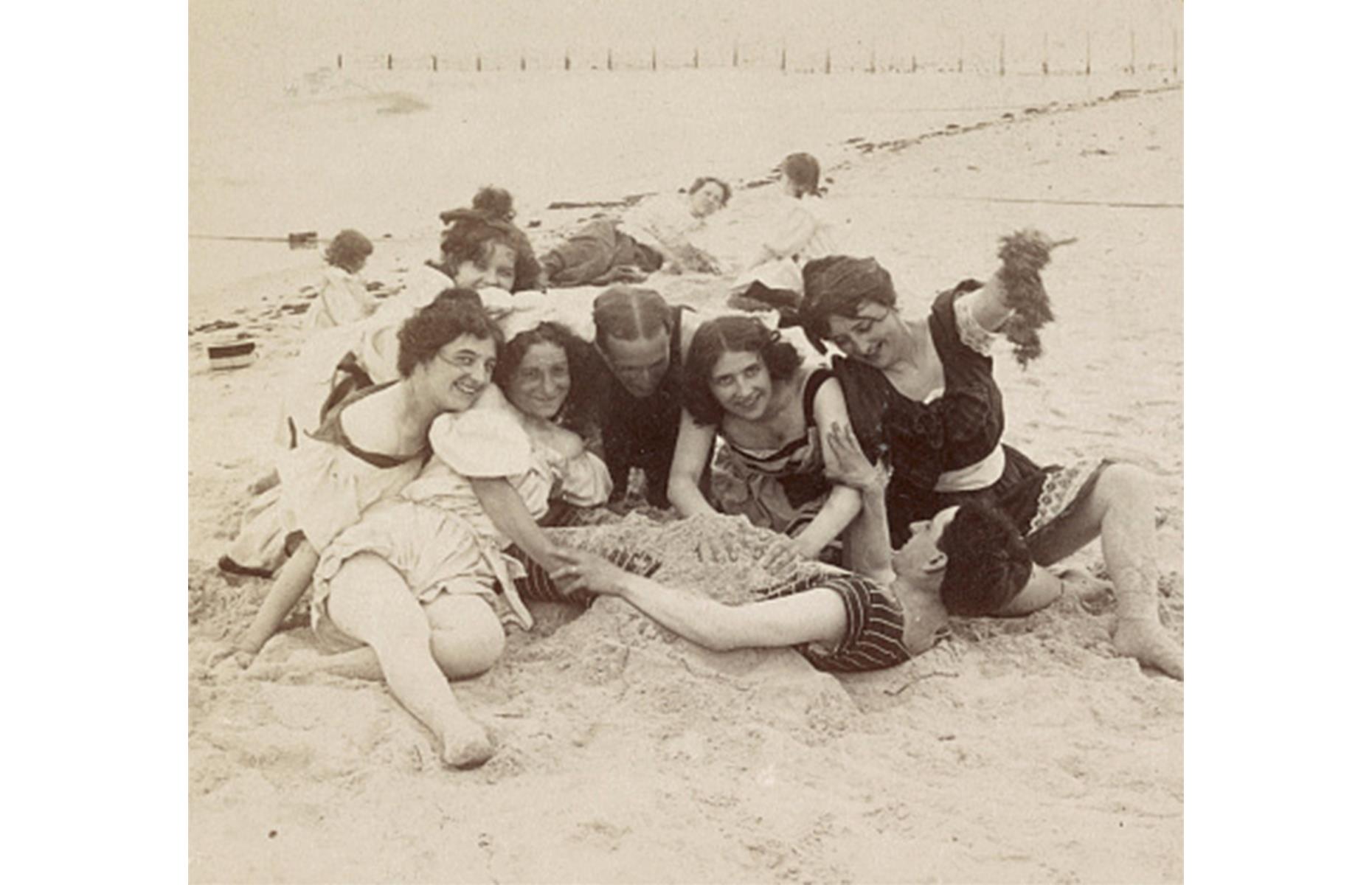 Despite Coney Island's rich pick of parks and amusements, the beach alone was enough for some vacationers. This photo dates right back to 1897 and captures a group of young sun-seekers burying their friend in the sand.