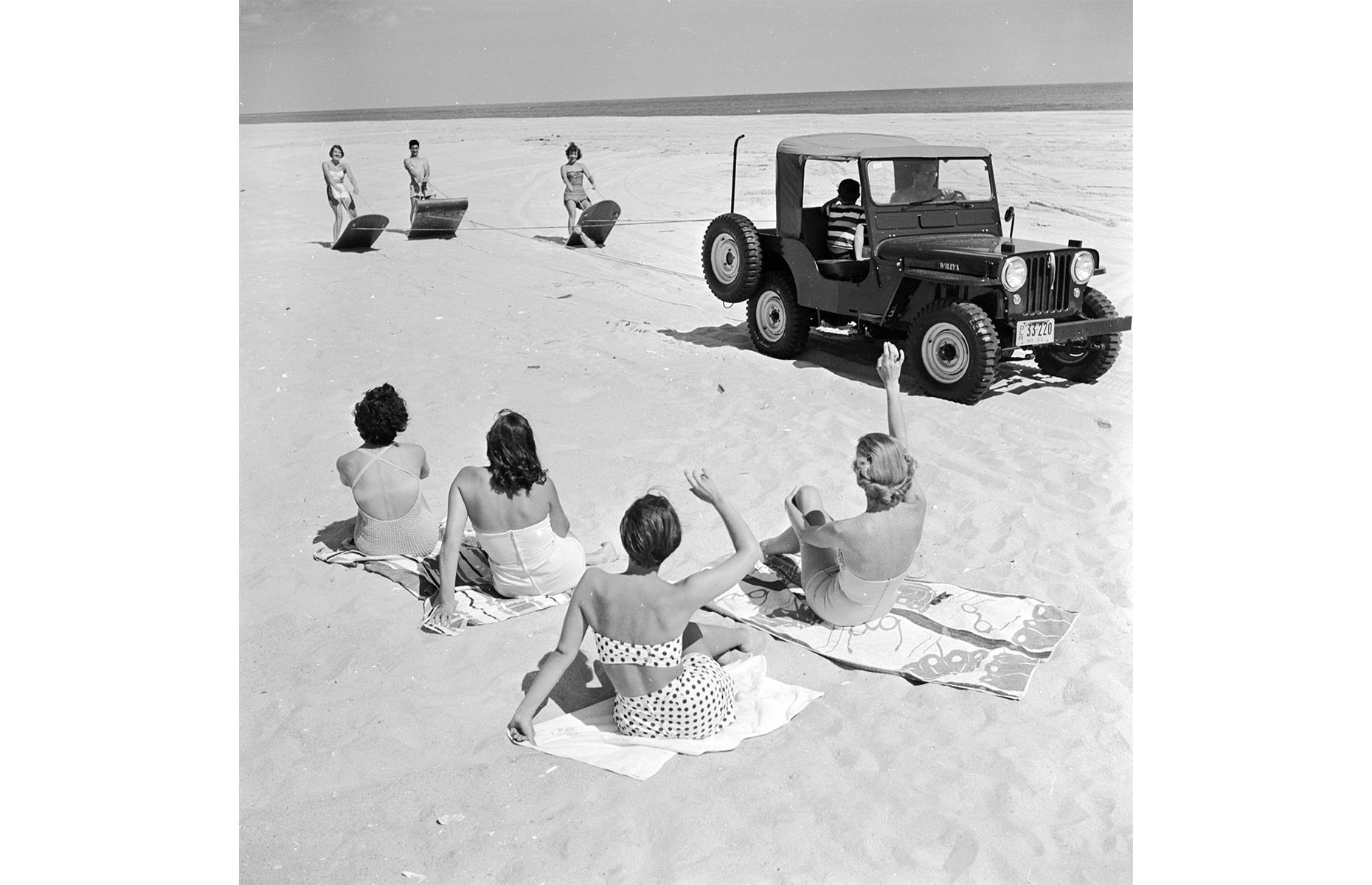 East of Coney Island, the hotels and resorts of Long Island attracted more wealthy vacationers, who relaxed in upscale areas such as The Hamptons. This dreamy stretch of sand is located close to Southampton. Pictured here in the 1950s is a group of young sun-worshippers, some of them sand-surfing off the back of an ATV.