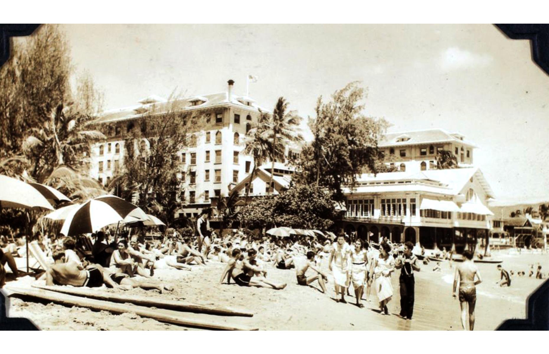The Aloha State has long been a top place for a seaside getaway too – and an enduring hot spot has been Waikiki Beach, a glorious sandy strand hemming Honolulu's Waikiki neighborhood. Possibly taken circa 1930, this photo shows beach-goers gathered before the beautiful Moana Surfrider Hotel.
