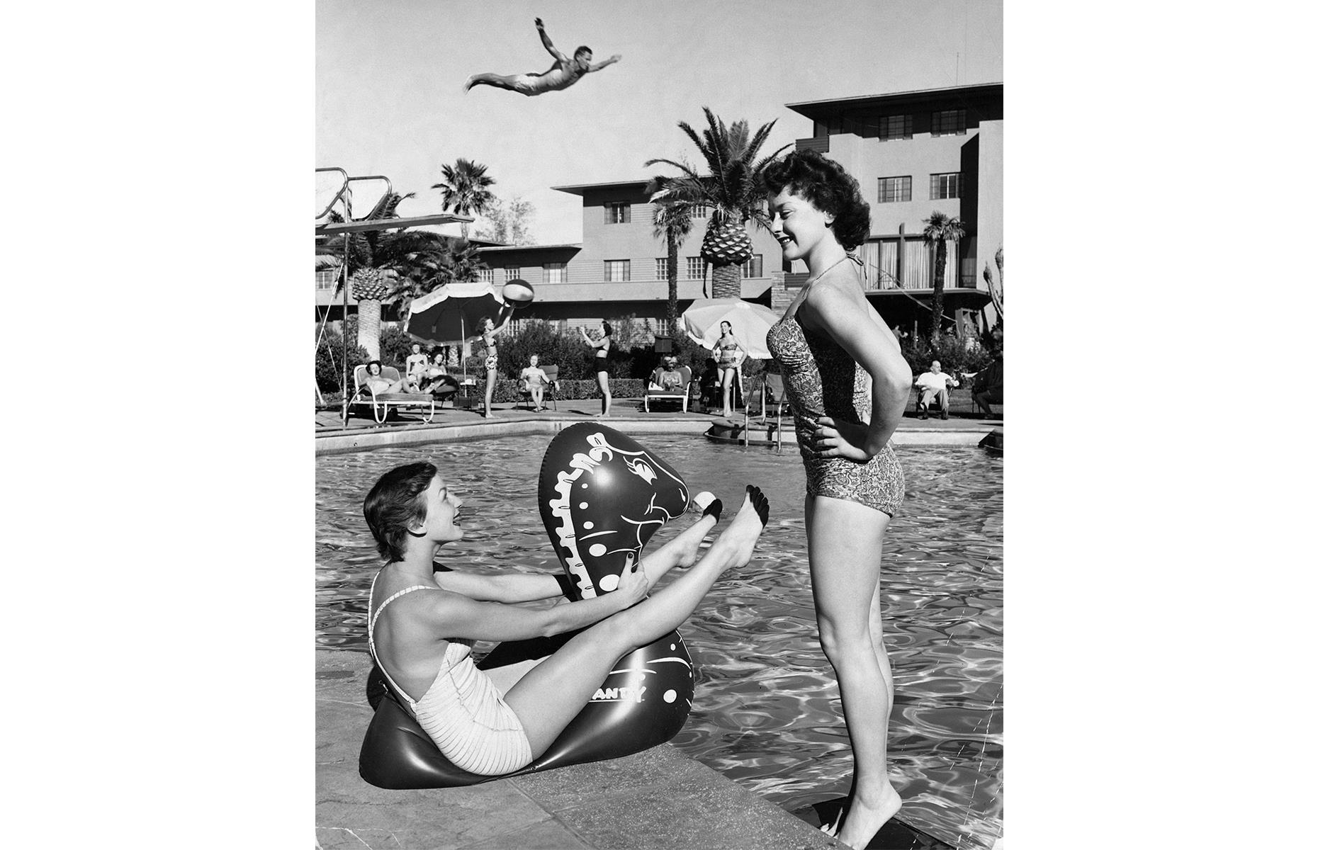Away from the coast, Las Vegas was the pleasure-seeker's vacation spot of choice. Plush hotels and resorts sprang up in Sin City in the Forties and Fifties, as the legendary Strip continued to develop. Here, well-heeled holidaymakers let their hair down around the pool at this Vegas resort in 1955.