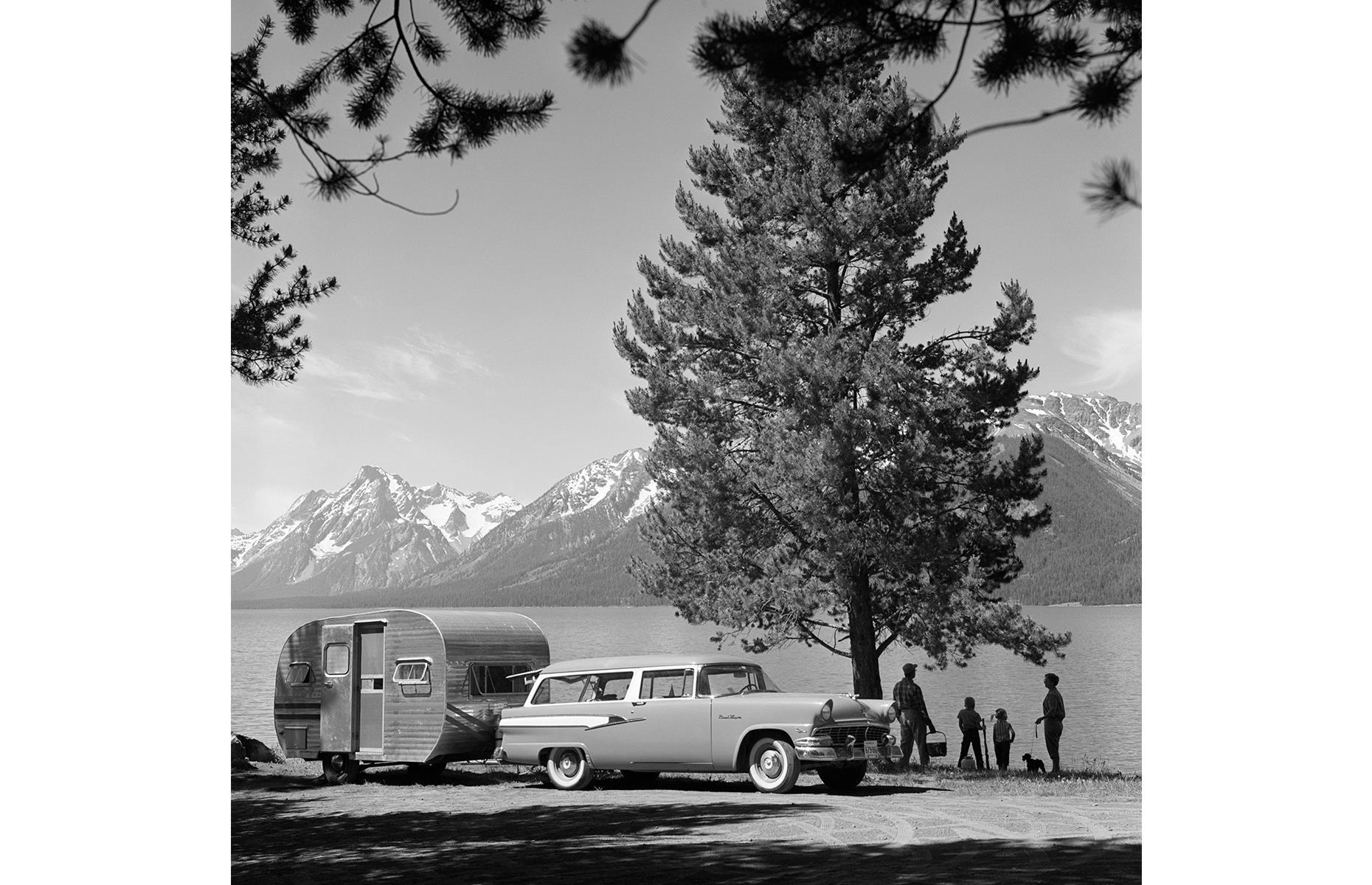 <p>America's national parks have also long served as summer vacation spots for adventurous travelers. This family, photographed in the 1950s, have parked up their trailer in a wonderfully scenic spot in Grand Teton National Park. They look out across Jackson Lake, the mighty Teton range jutting towards the sky. </p>  <p><strong><a href="https://www.loveexploring.com/galleries/107668/historic-photos-of-americas-national-parks?page=1">See more vintage photos of America's national parks</a></strong></p>