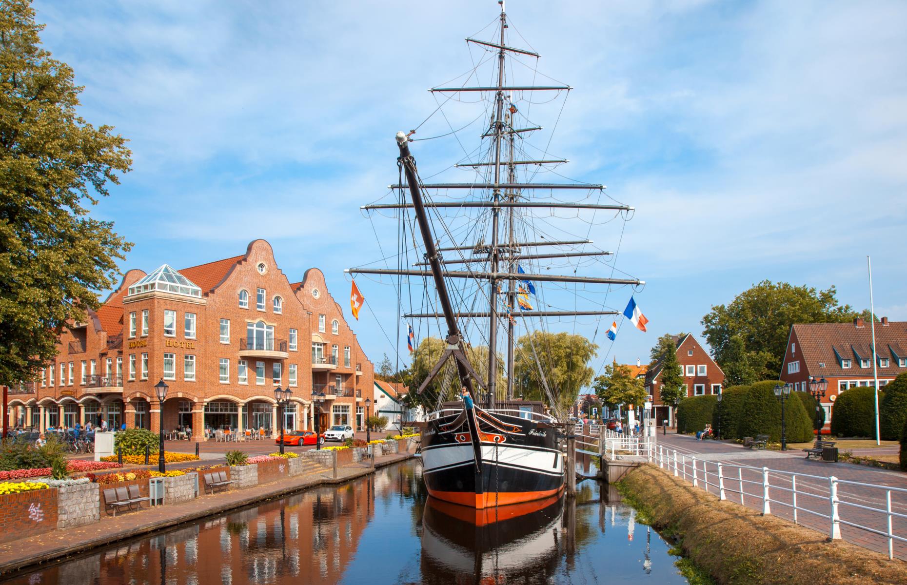 <p>The views are unrelentingly glorious, from meadows with picture-book windmills to nature reserves. Back in <a href="https://www.niedersachsen-tourism.com/destinations/cities-in-lower-saxony/papenburg">Papenburg</a>, a vibrant port city known for shipbuilding, several museums trace the history of sailing and the shipping industry in the region. The city is also laced with canals, crossed by bascule bridges (drawbridges) and dotted with permanently moored, historic ships (pictured).</p>