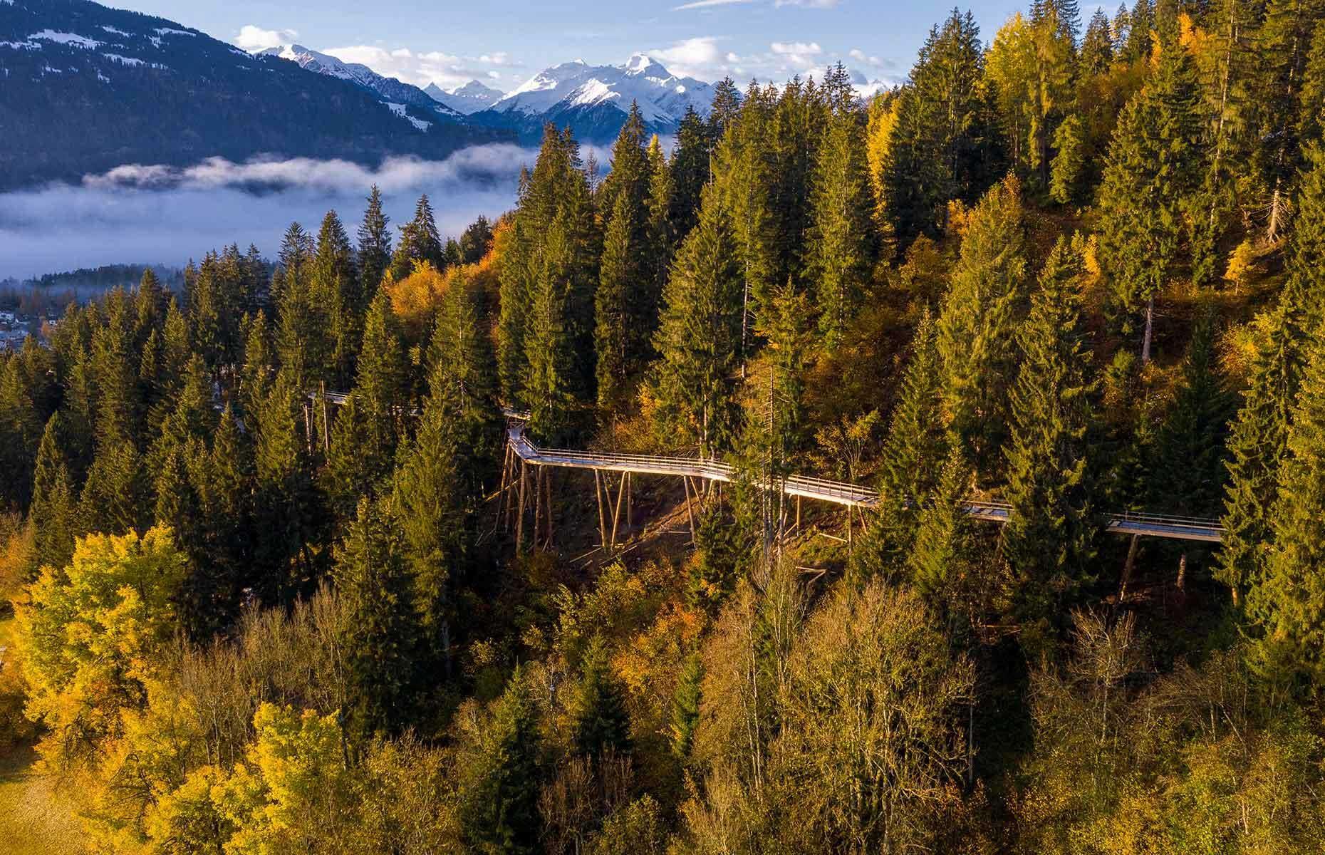 <p>This July, the Swiss ski resort town of Laax gained a stunning new attraction: the Path of the Dragon. This 0.97-mile (1.56km) walkway, perched as high as 92 feet (28m) above the ground at the highest point, is the world's longest treetop walkway. It's the perfect spot for admiring the region's breathtaking alpine views – but it's also a sight to behold from above, with the wooden path spiraling its way through a thick carpet of greenery. </p>  <p><strong><a href="https://www.loveexploring.com/galleries/81954/54-of-the-worlds-most-incredible-photos-from-above?page=1">Loved this? See our incredible planet photographed from above too</a></strong></p>