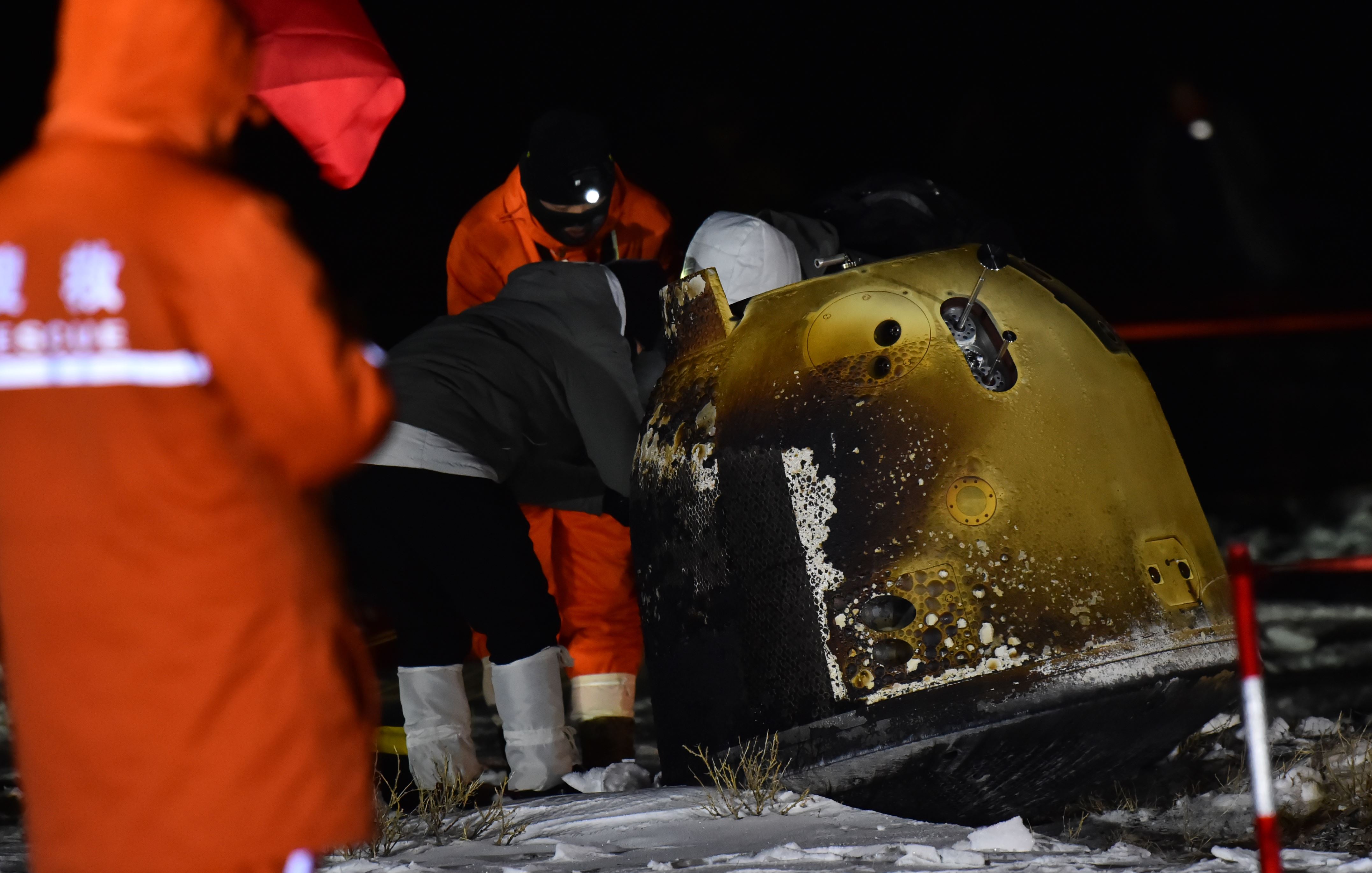 SIZIWANG BANNER, CHINA - DECEMBER 17: Staff members work at the landing site of the return capsule of Chang'e-5 probe, which is carrying soil and rocks from the moon, on December 17, 2020 in Siziwang Banner, Inner Mongolia Autonomous Region of China. (Photo by Ma Jianbing/VCG via Getty Images)