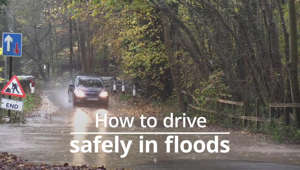 a sign on the side of a road: How to drive safely in floods