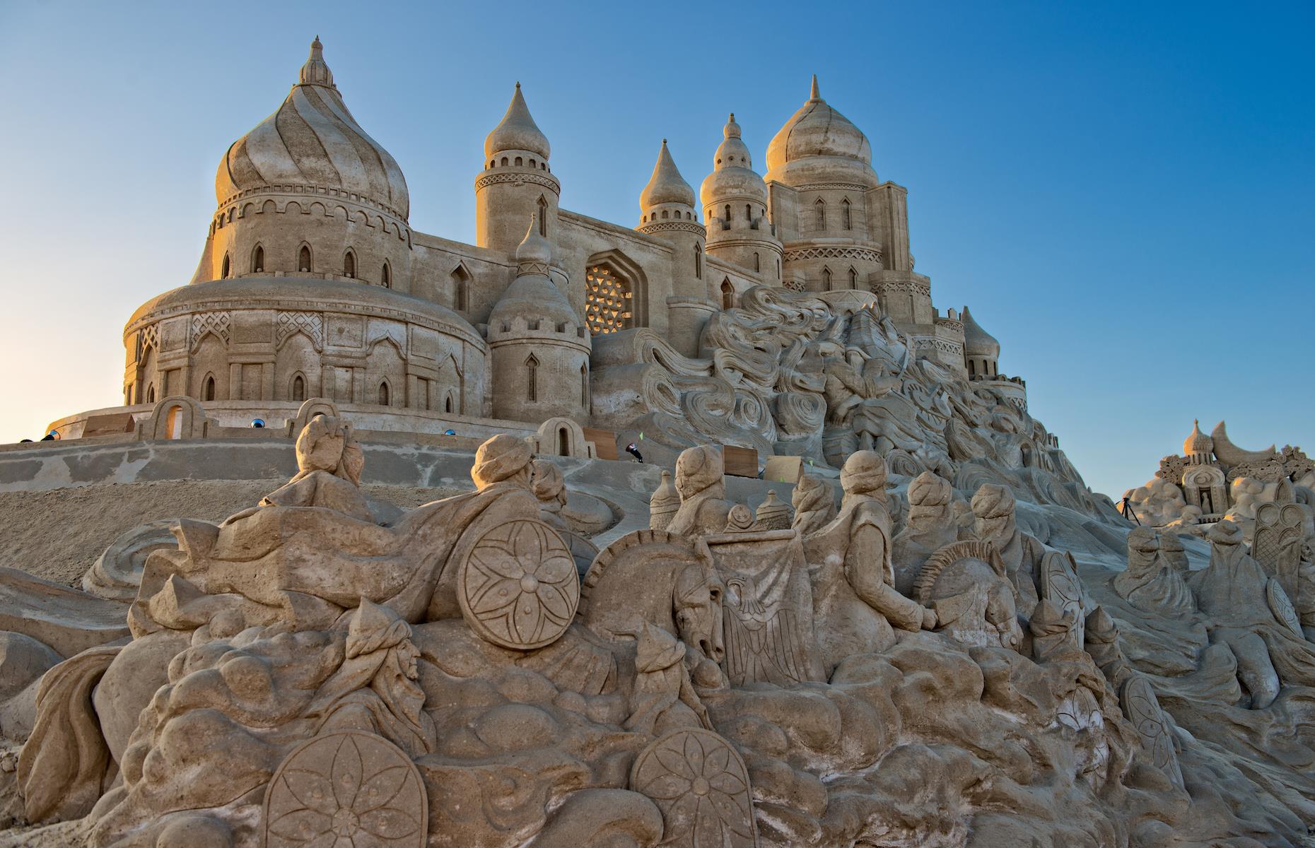 <p>Inspired by the Middle Eastern folktale collection, <em>One Thousand and One Nights</em>, this epic sand “village” was on display at the Remal International Festival in Kuwait in 2014. The magical world reportedly covered an area of 322,917 square feet (30,000sqm) and used more than 31,000 tons of sand. As well as grand domed palaces, minarets and traditional little villages, the sprawling artwork included fearsome snakes, a giant genie and gruesome skeletons. Lit up at night, it was even more enchanting.</p>  <p><strong><a href="http://bit.ly/3roL4wv">Love this? Follow our Facebook page for more travel inspiration</a></strong></p>