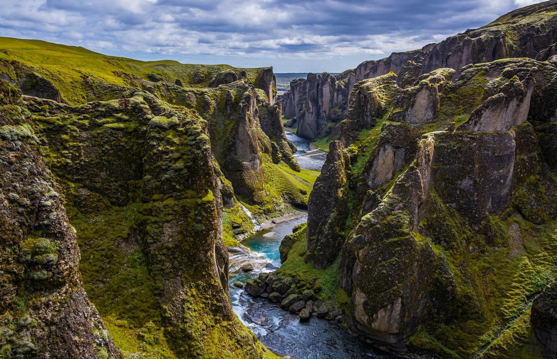 <p>A natural landscape that is almost too awe-inspiring to believe, Fjaðrárgljúfur was carved through the earth over millions of years, all thanks to the natural flow of the Fjaðrá River. The imposing canyon can be found to the west of the village of Kirkjubæjarklaustur, on the island's south coast, and boasts enchanting walking paths that weave among towering rock formations. Soak up the unparalleled scenery from the top, or head down to immerse yourself in the quiet beauty of the canyon's glacial brook.</p>