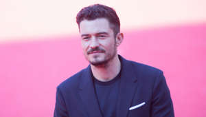 Orlando Bloom looking at the camera: Orlando Bloom is often seen mountain biking on extreme terrain and has also tried his hand at Formula E racing.  Orlando even starred in Andy Samberg’s cycling mockumentary ‘Tour de Pharmacy’ where he played Italian cyclist JuJu Peppi. As well as mountain biking, Bloom also cycles a lot on the roads as has been spotted cycling around New York city and Malibu.