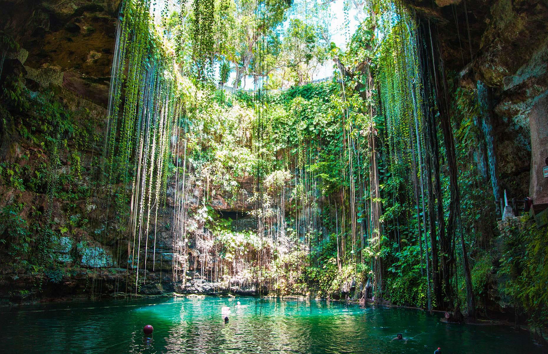 Ik Kil, a natural cenote (or sinkhole) in Yucatán, Mexico, was formed during heavy tropical rainfall which made its original limestone ceiling collapse. It's a picturesque natural attraction that really looks like it could be a passageway into a lost world. The spot is considered sacred by the Mayan people and a swim in the pool's mesmerising green waters is truly magical.