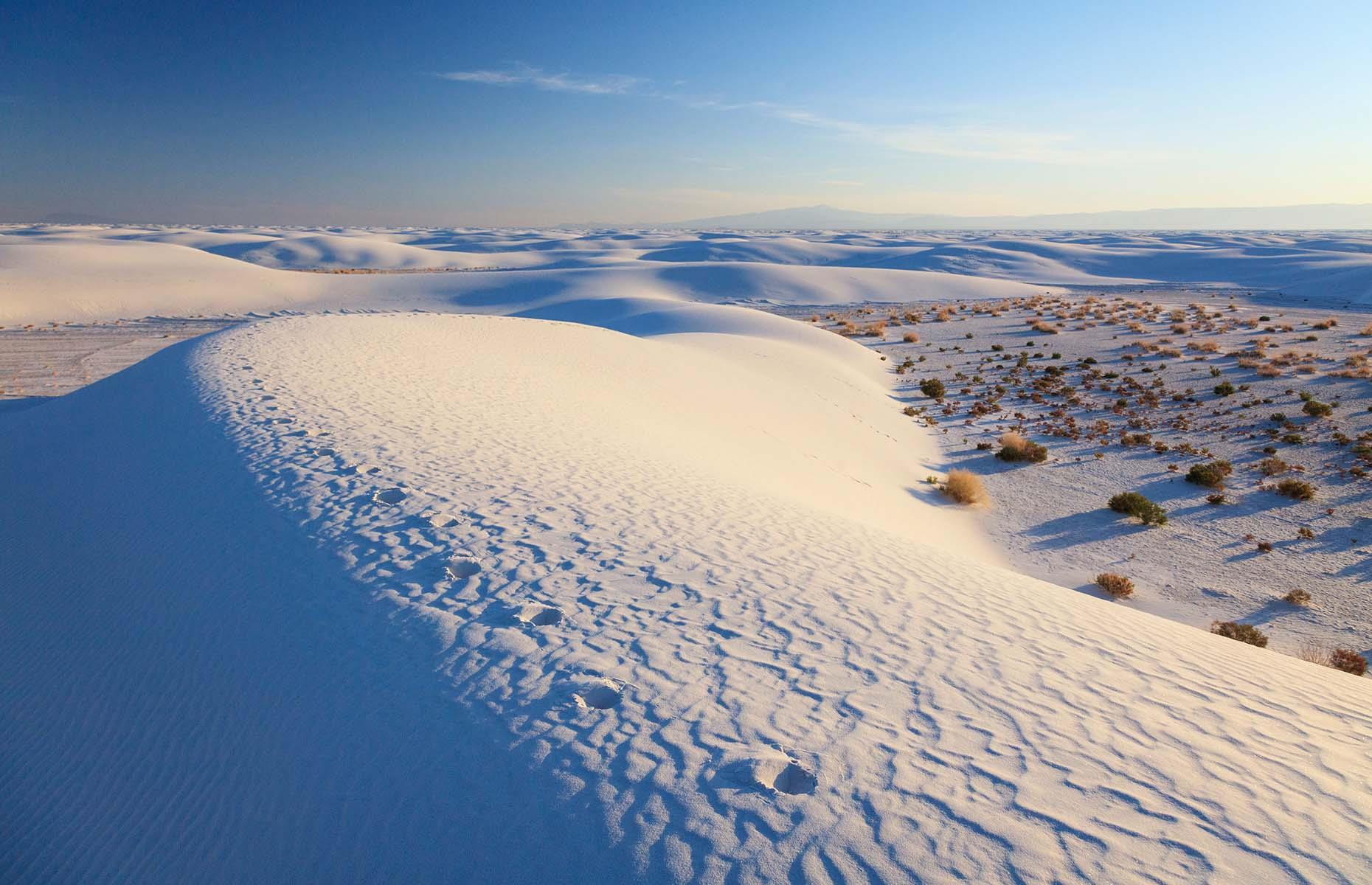 Mystical and magical, the expansive desert of White Sands National Park is one of nature’s most unusual marvels. Covering 275 square miles (712sq km) inside New Mexico's Tularosa Basin, the dunes are formed from gypsum sand – a rare mineral found in only a few locations on Earth. The sand dissolves in water but luckily the state's dry climate is the perfect breeding ground for this unique and wonderful material.