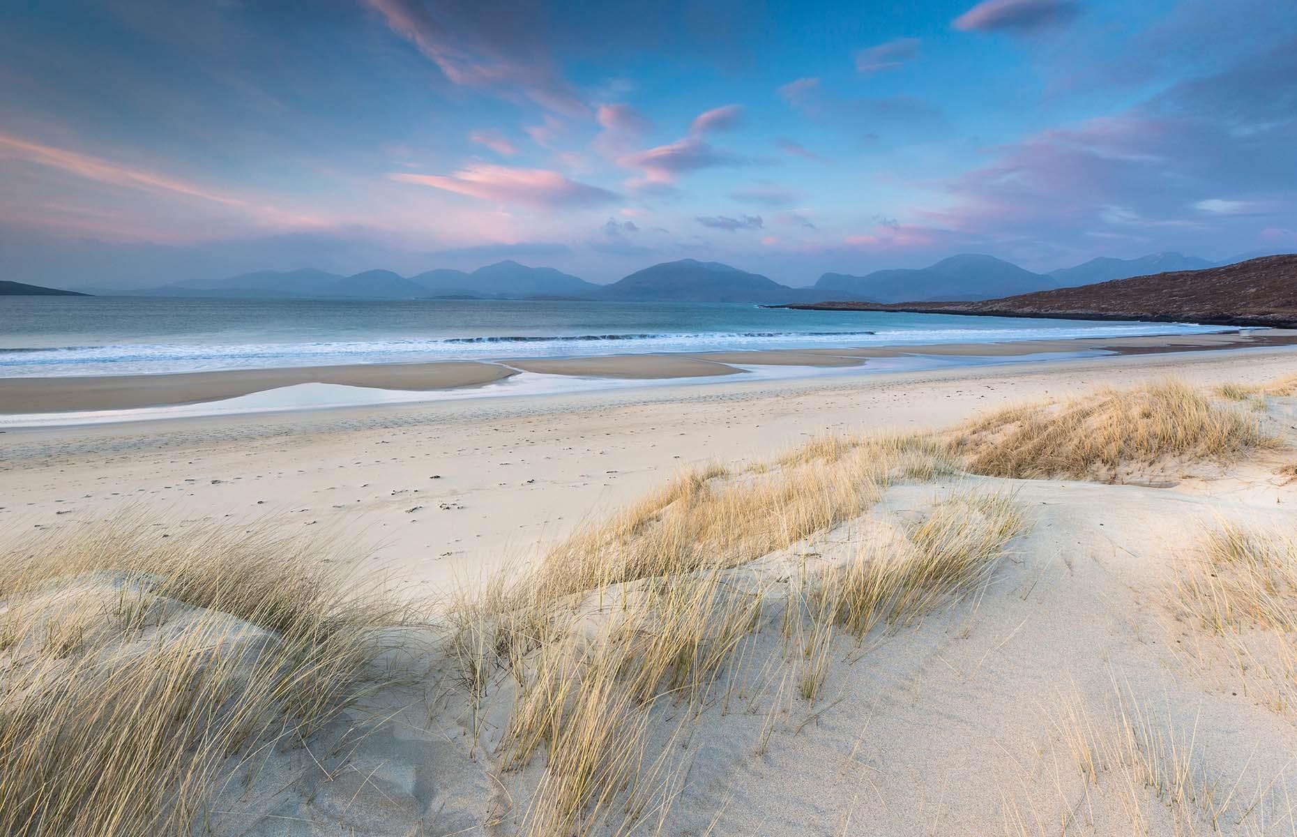 Tucked away on the western shores of South Harris in the Outer Hebrides, Luskentyre Sands is easily one of the most untouched places in the country. With miles of pristine white sand and eye-popping blue waters, it's often voted the most beautiful beach in the UK. Framed by the soaring peaks of the North Harris mountain range, the beach is Scotland’s version of a tropical paradise.