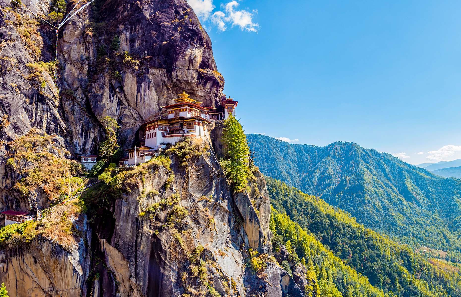 One of the world’s most precariously-placed monasteries, Paro Taktsang (better known as the Tiger’s Nest) perches tentatively on a cliffside in the upper Paro valley in Bhutan. The elegant structure is built around a cave in the cliff face that is said to have been used by Guru Padmasambhava for meditation in the 8th century. Legend has it he flew to the cave on the back of a tigress from Khenpajong.