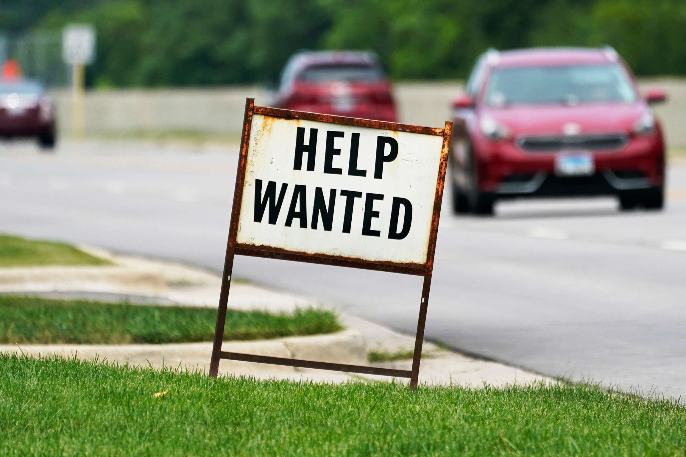A help-wanted sign is displayed at a gas station in Mount Prospect, Ill.