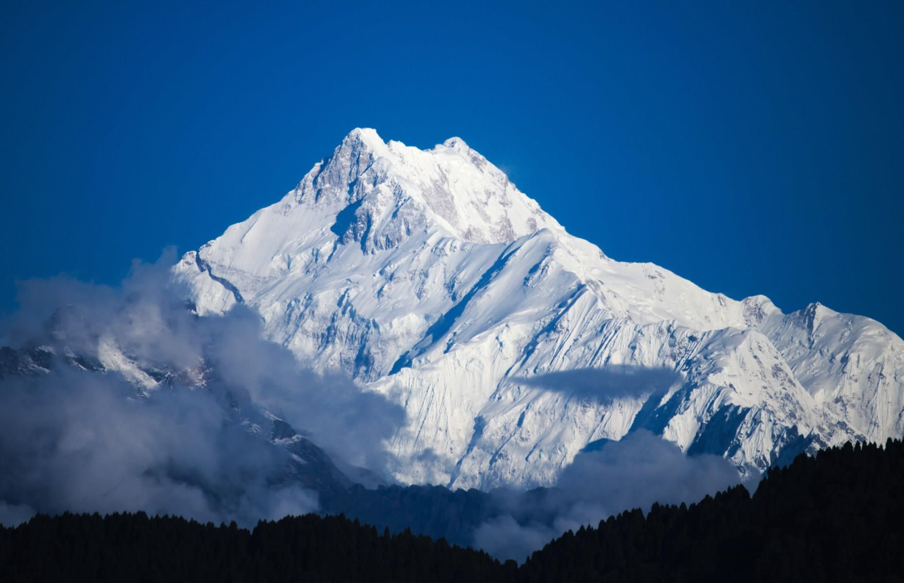 <p>Kanchenjunga is the second-highest Himalayan peak and the third-highest on Earth at an eye-watering 28,169 feet (8,586m) tall. It’s located in the eastern part of the mountain range on the Nepal-India border. Although shorter than Everest, it’s considered a more treacherous climb since less is known about it – <a href="https://indianexpress.com/article/explained/explained-why-climbing-mount-kanchenjunga-is-still-a-challenge-for-those-who-have-scaled-everest-5734121/">just around 20-25 people attempt to summit each year</a> compared to the 300-350 that climb Everest. </p>