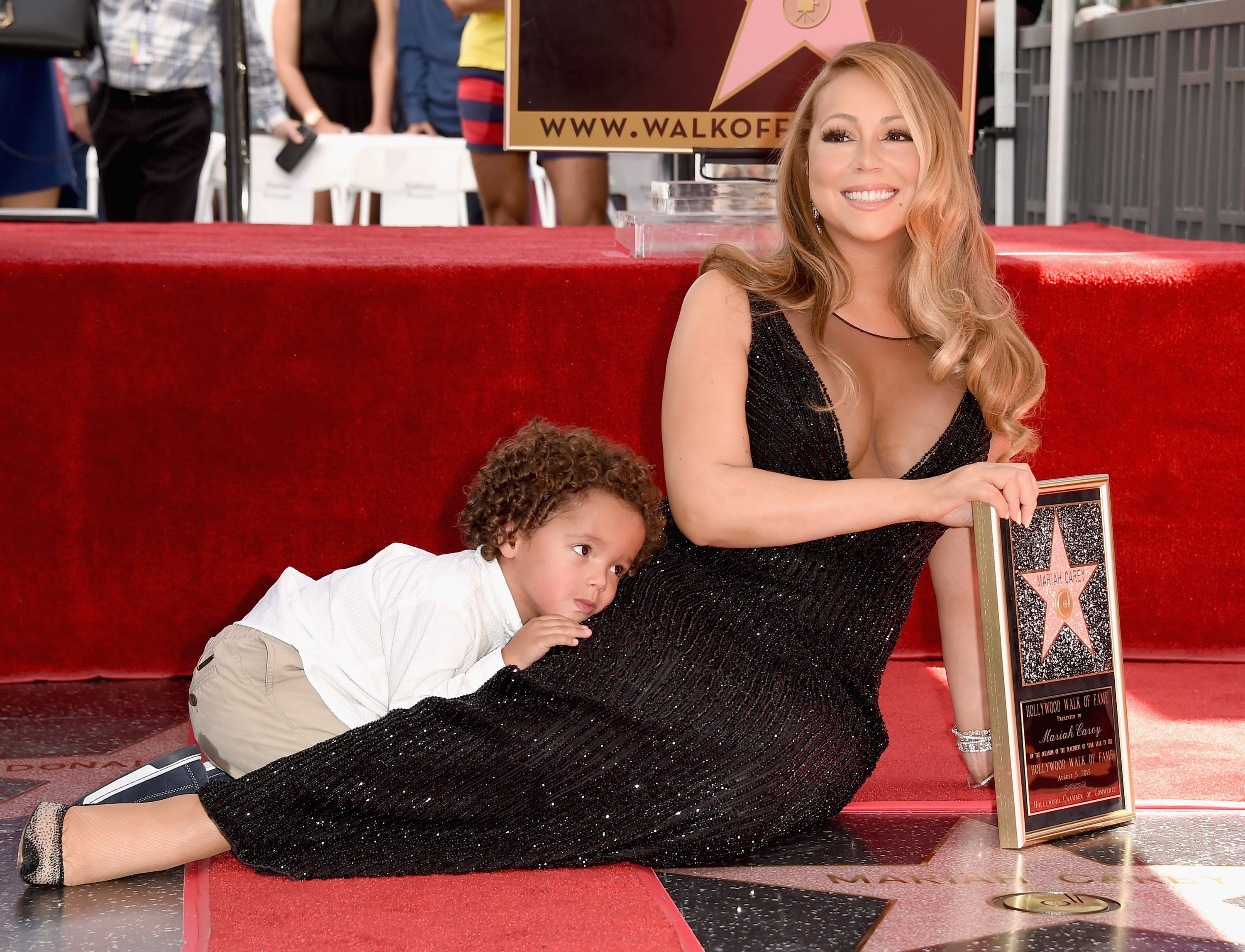 Mariah Carey was photobombed by her son Moroccan as she posed with her star in August 2015.