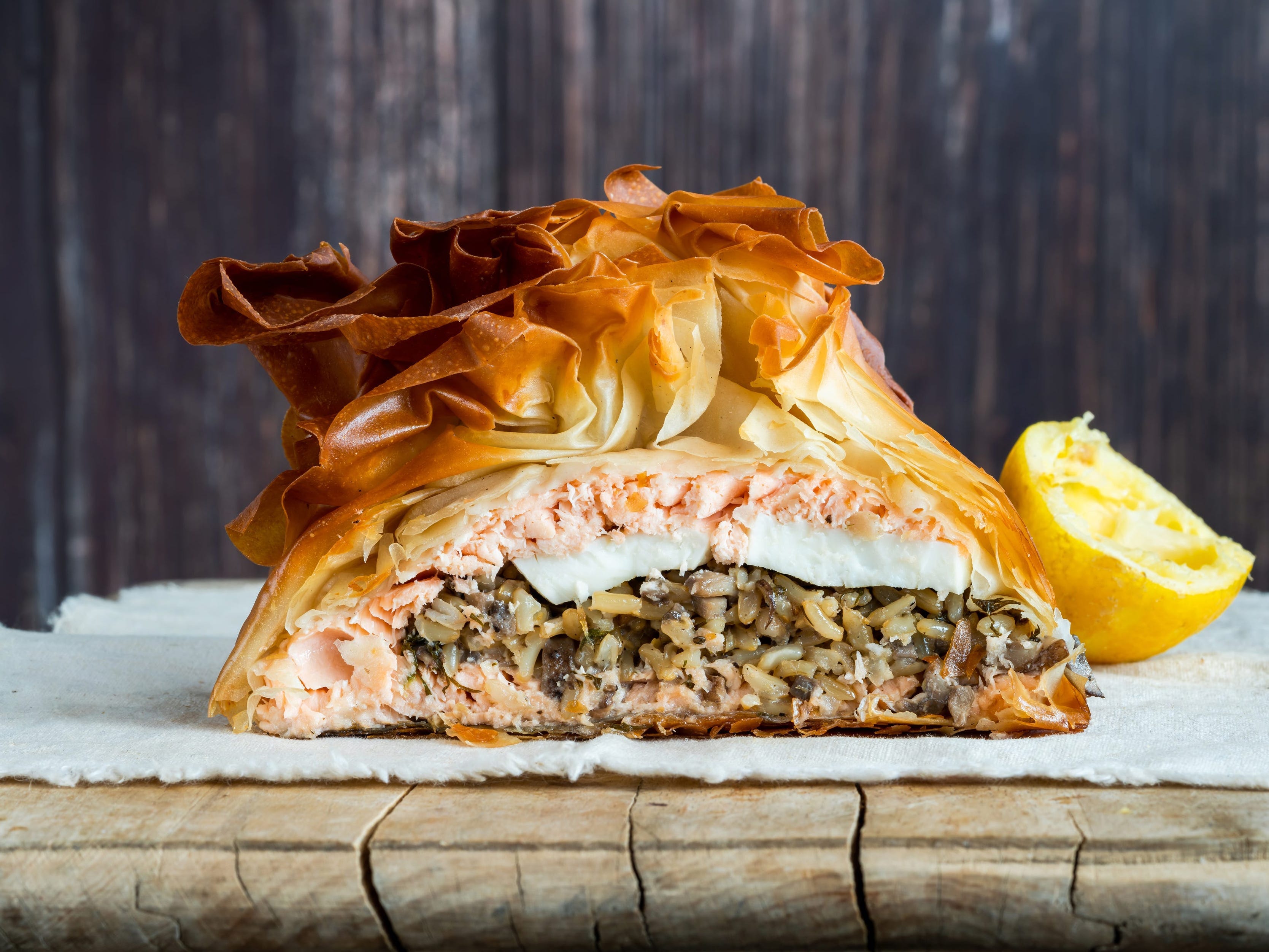 <p>This Russian specialty makes for a stunning centerpiece. </p><p><a href="https://www.bbcgoodfood.com/recipes/salmon-coulibiac">According to BBC Good Food</a>, coulibiac is filled with fish, rice, onions, dill, and spices like cumin, coriander seeds, cardamom, and star anise. </p><p><a href="https://www.nytimes.com/1976/12/27/archives/westchester-weekly-to-my-mind-the-worlds-greatest-dish-coulibiac.html">According to the New York Times</a>, the pie is almost always baked in a brioche or pastry shell.</p>