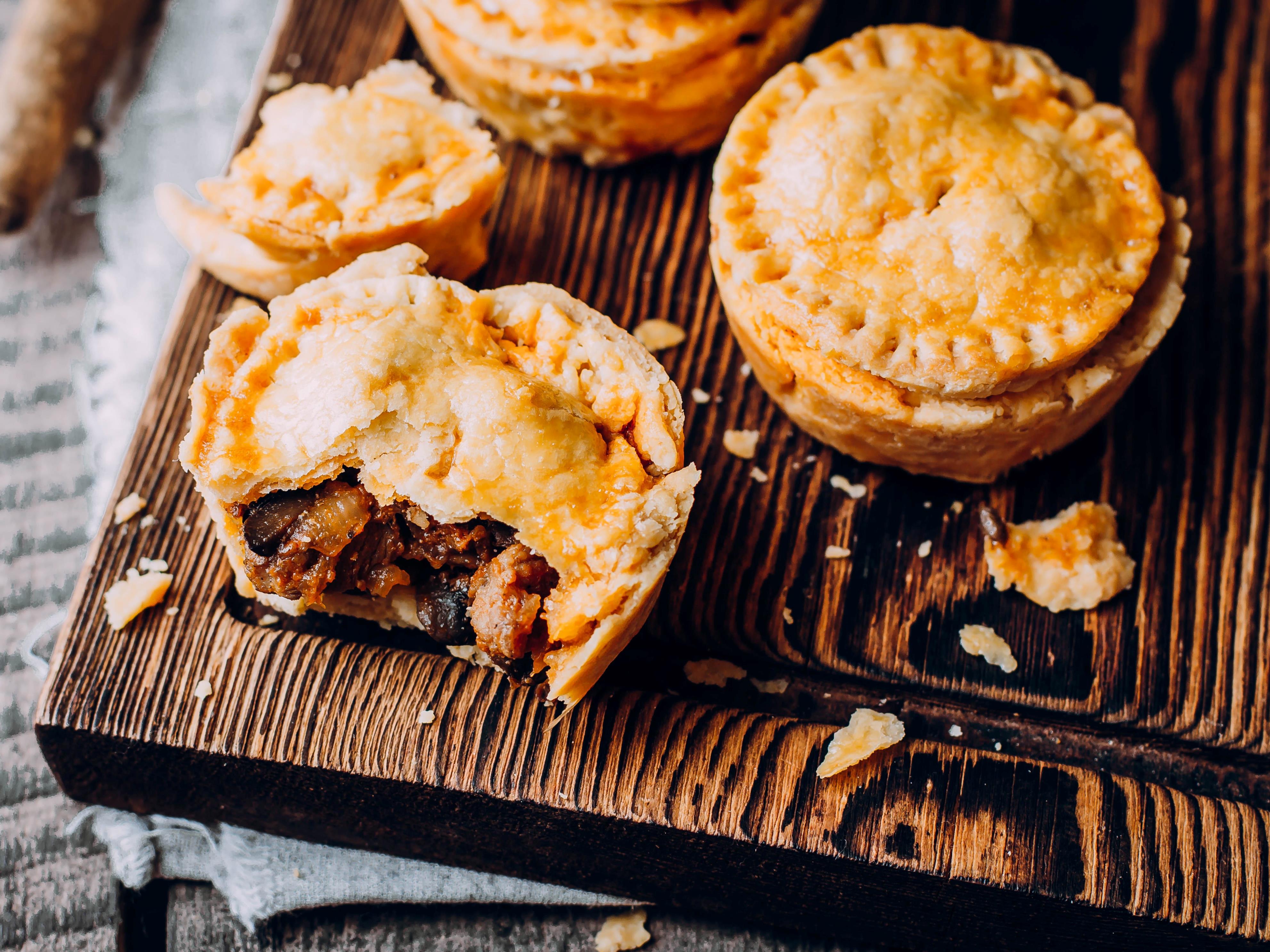 <p><a href="https://www.theguardian.com/lifeandstyle/australia-food-blog/2014/may/07/meat-pie-a-great-australian-dish">According to The Guardian</a>, these hand pies consist of beef and gravy, topped with tomato sauce.</p><p>The dish is so popular in Australia and New Zealand that the two countries' <a href="http://www.foodstandards.gov.au/consumer/generalissues/meatpie/Pages/default.aspx" rel="noopener">Food Standard code</a> states that meat pies must contain a minimum of 25% of meat flesh.</p>