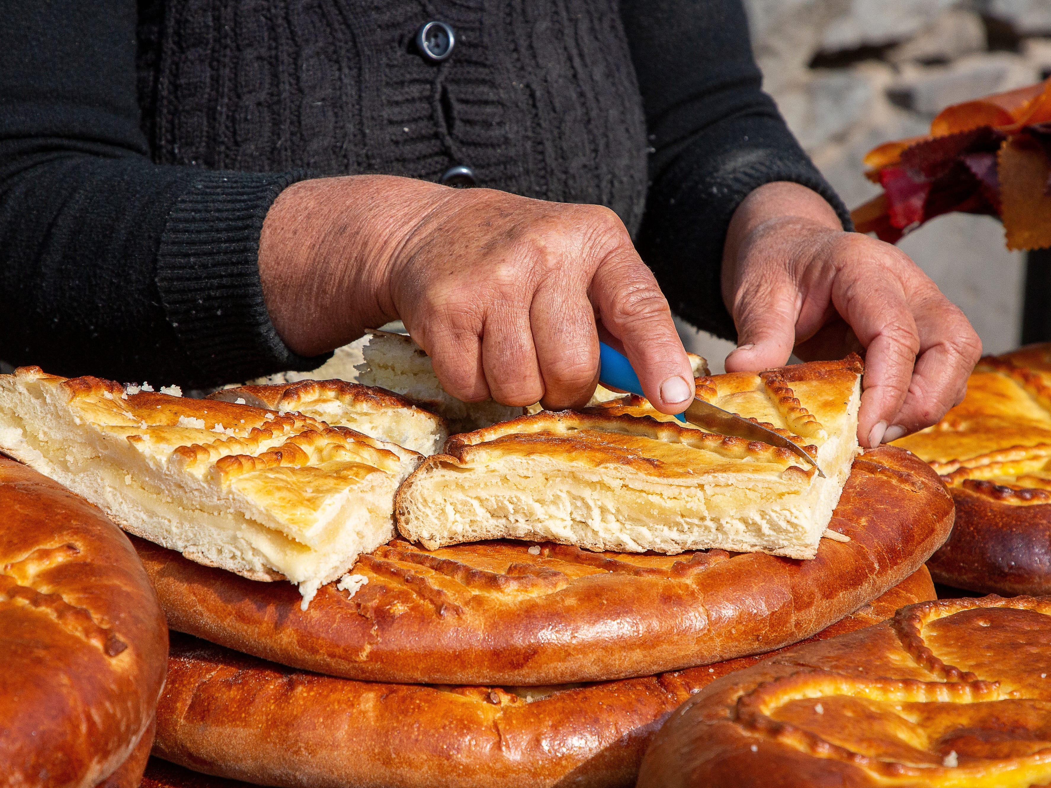 <p>There are many variations of gata in Armenia. No matter the shape, size, or form, it always pairs well with dark coffee or tea. </p><p><a href="https://www.seriouseats.com/gata-5185123">According to Serious Eats</a>, the light pastry is made from yeasted dough loaded with Greek yogurt and vanilla. </p><p>It's usually served on a flattened disc or rolled into handheld bites, topped with chopped nuts, and scored with decorative patterns. </p>