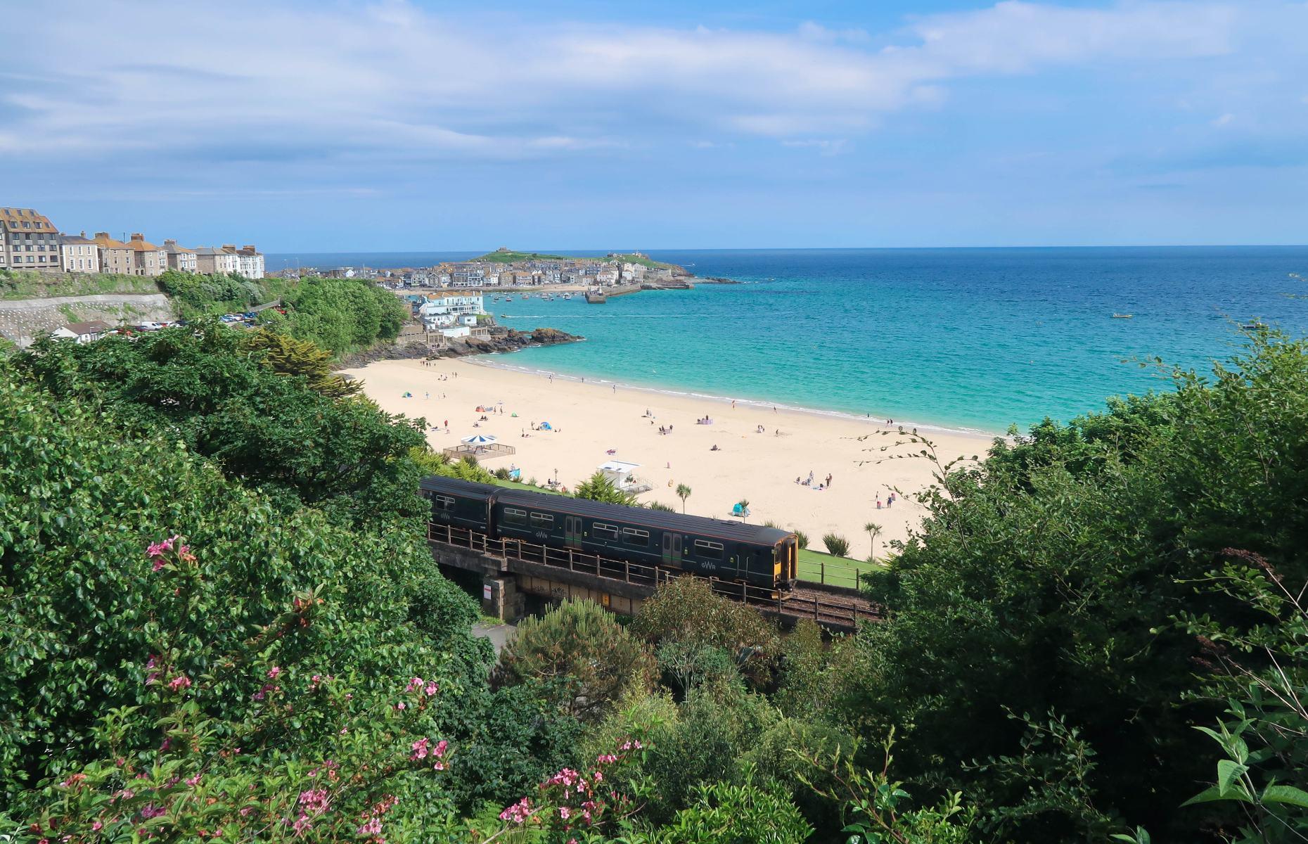 <p>Sweeping along Cornwall’s spectacular coastline, this 4.25 mile (6.8km) route is arguably one of the most beautiful train rides of its kind in England. In just 15 minutes, <a href="https://www.stives.co.uk/st-ives-bay-line">the railway</a> travels from St Erth past the sparkling sands and eye-popping blue waters of Carbis Bay and Hayle Towans before arriving at the popular seaside town of St Ives. With its close proximity to the beaches, the train provides unobstructed views across the coast.</p>