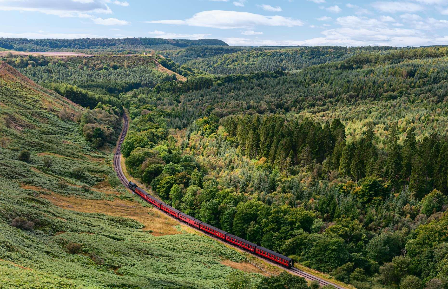 <p>Considered one of the greatest heritage railways in the UK, the <a href="https://www.nymr.co.uk/">North York Moors line</a> has been slicing through Yorkshire’s incredible countryside since 1836. Its vintage steam and diesel trains transport passengers 24 miles (38.6km) back in time through the North York Moors National Park, from the pretty market town of Pickering to the historic seaside resort of Whitby. There are plenty of beautiful sights and fun attractions along the way, including the lovely village of Levisham and the famous Goathland Station which served as the original Hogsmeade Station in <em>Harry Potter and the Philosopher’s Stone</em>.</p>  <p><a href="https://www.loveexploring.com/guides/88897/what-to-see-where-to-stay-north-york-moors"><strong>Inspired? See our guide on what else to do in the North York Moors</strong></a></p>