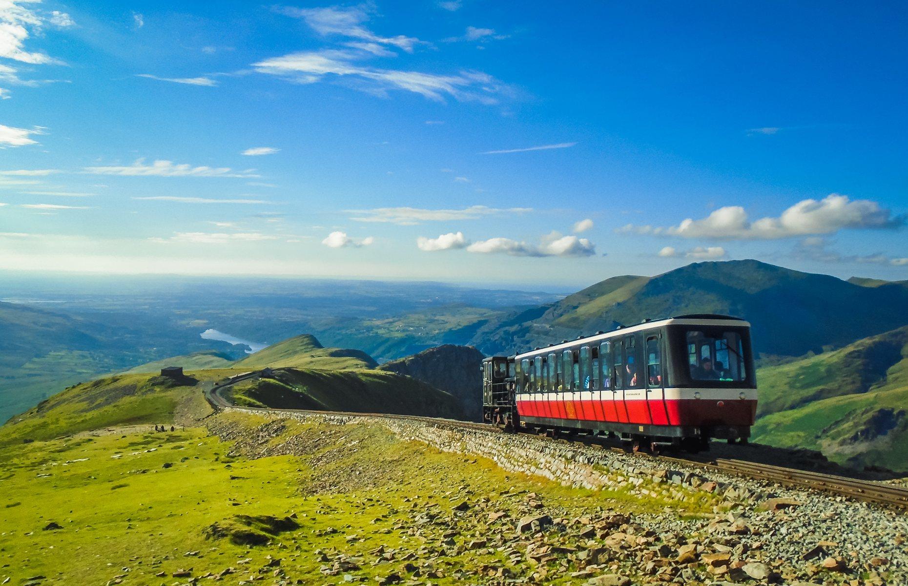 <p>Travelling up and down the highest peak in England and Wales, the <a href="https://snowdonrailway.co.uk/">Snowdon Mountain Railway</a> has been serving passengers since 1896. From the town of Llanberis, the steam train climbs four miles (6.4km) to the rocky summit of Snowdon through some of Wales’ most jaw-dropping scenery. Soaring 3,560 feet high (1,075m) at its peak, the journey provides incredible panoramic views across Snowdonia.</p>  <p><a href="https://www.loveexploring.com/gallerylist/72078/best-british-tourist-attractions"><strong>Discover more of the best British tourist attractions</strong></a></p>