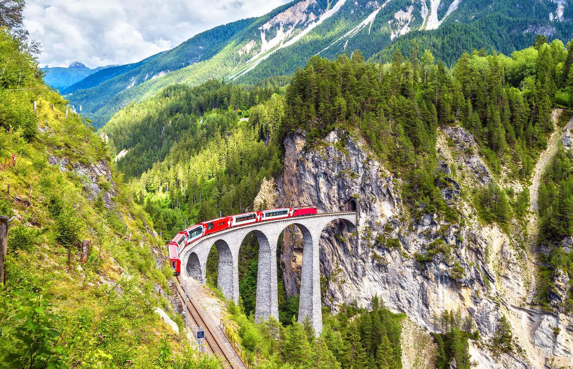 <p>The slowest express service in the world, Switzerland's <a href="https://www.zermatt.ch/en/arrival/Glacier-Express">Glacier Express</a> takes a whooping eight hours to cover a distance of just 181 miles (291km). That's because the scenic route takes in sights like Oberalp Pass, the highest point of the journey, and the Landwasser Viaduct – a six-arch bridge which stands at 213 feet (65m) and plunges straight into a tunnel that leads through the mountain. The day-long trip covers 91 tunnels, 291 bridges and offers the chance to take in stunning alpine meadows, mountain lakes and chalets. </p>