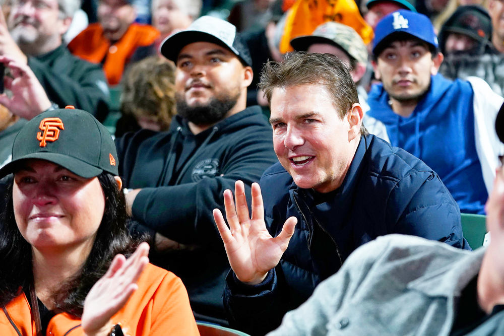 <p>Tom Cruise waves during Game 2 of a baseball National League Division Series between the San Francisco Giants and the Los Angeles Dodgers, in San Francisco on Oct. 9, 2021.</p> <p>He was joined by his son Connor, who lives a private life near Clearwater, Florida, where the Church Of Scientology is headquartered. He likes to share his deep water fishing adventures and cooking skills on social media, but keeps private beyond that.</p>
