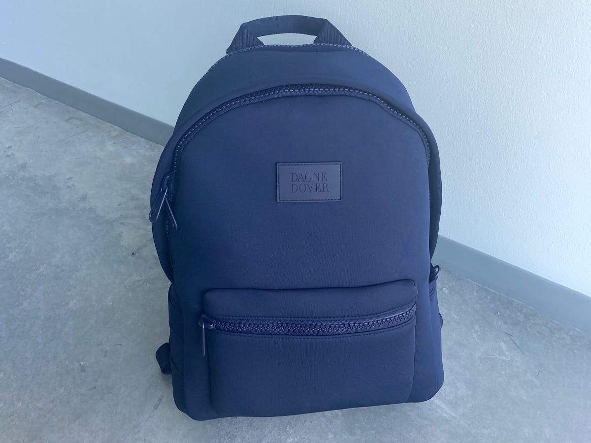 <div class="bi-product-card"><div class="product-card-options"><div class="product-card-option"><div class="product-card-button"><a href="https://www.dagnedover.com/collections/the-dakota-backpack#Onyx-Large"><span>$200.00 FROM DAGNE DOVER</span></a></div></div></div></div><p>If you like a minimalistic design with ample space and clever compartments, this neoprene bag will be your saving grace. It's water-resistant, shock-absorbent, and has sleek straps. Inside, there are pockets galore, and no space is wasted! The laptop compartment fits a 16-inch laptop which is bigger than the average college device. The main compartment holds up to 20 liters and has a mesh tablet pocket, five medium-sized pockets, and a convenient detachable pouch. Two exterior pockets can carry your water bottle and a stash of snacks. </p><p>I can confidently say this backpack fits <em>everything </em>I would ever need: my laptop, tablet, textbooks, water bottle, notebook, snacks, and a spare pair of shoes. On the outside, it looks chic and simple, but inside, it gives you all the power to be your most organized self. It even has a nearly-invisible slip pocket by the handle where you can keep small items like a snack or headphones. </p><p>One of my favorite features is the luggage handle sleeve that allows you to slide the backpack onto any suitcase you're wheeling around.</p>