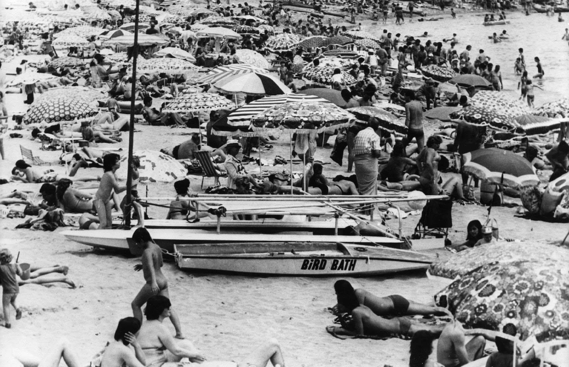 There was a steady uptick in tourism from the 1950s and 1960s onwards, as package vacations became a little more affordable. By the 1980s, Spain's beaches were thronged with people come summertime. Here, families cruise on inflatables in the ocean or sit elbow-to-elbow on the shores, shading themselves under umbrellas. This snap was taken in Palamós, another top Costa Brava destination for Brits, in 1981.