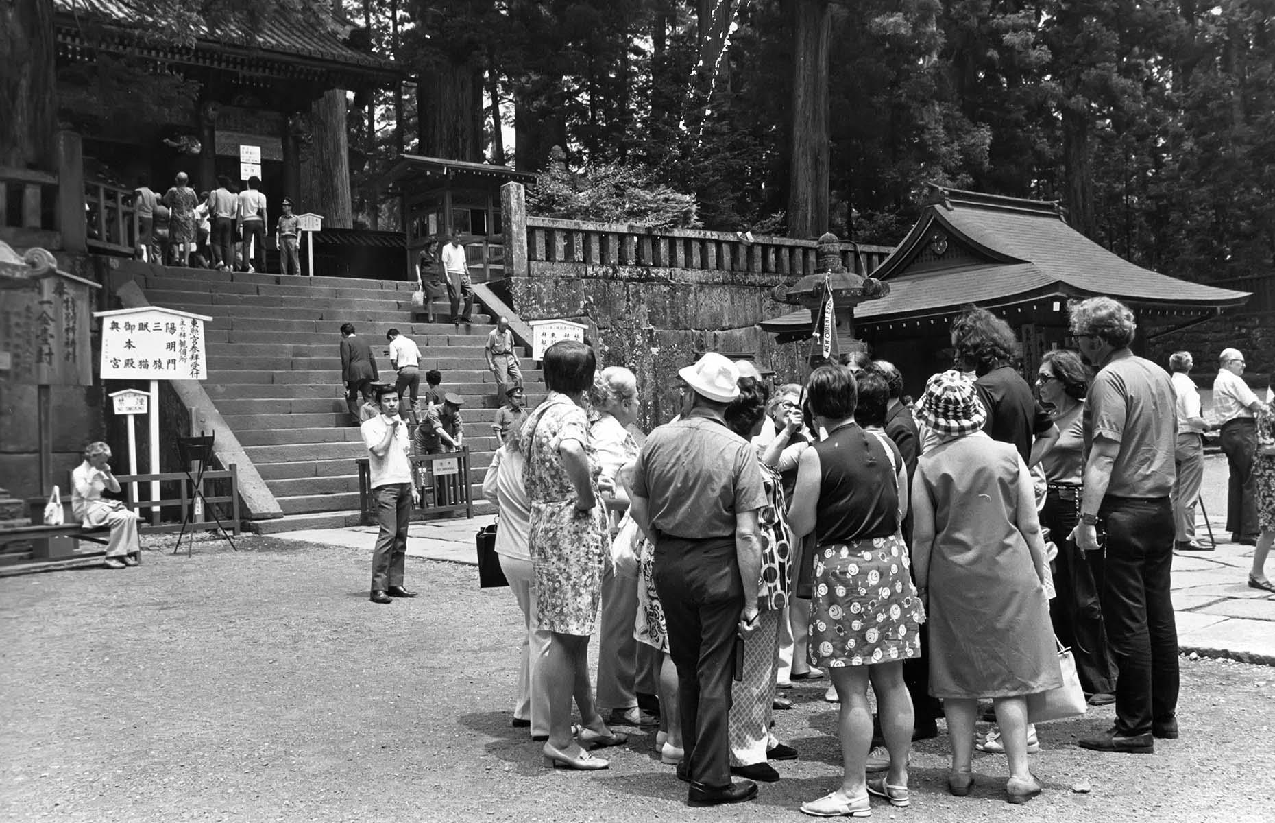 <p>In the decades following the Second World War, Western interest in Japan only increased and by the 1970s the memories of the conflict had faded. Tour groups and individual travelers from European countries and the US traveled to Japan in large numbers, keen to see this fascinating country and learn about its history. In this captivating shot from 1974, that could easily be mistaken for a tour group today with the guide's flag raised in the air, American tourists have gathered to tour Nikko National Park.</p>